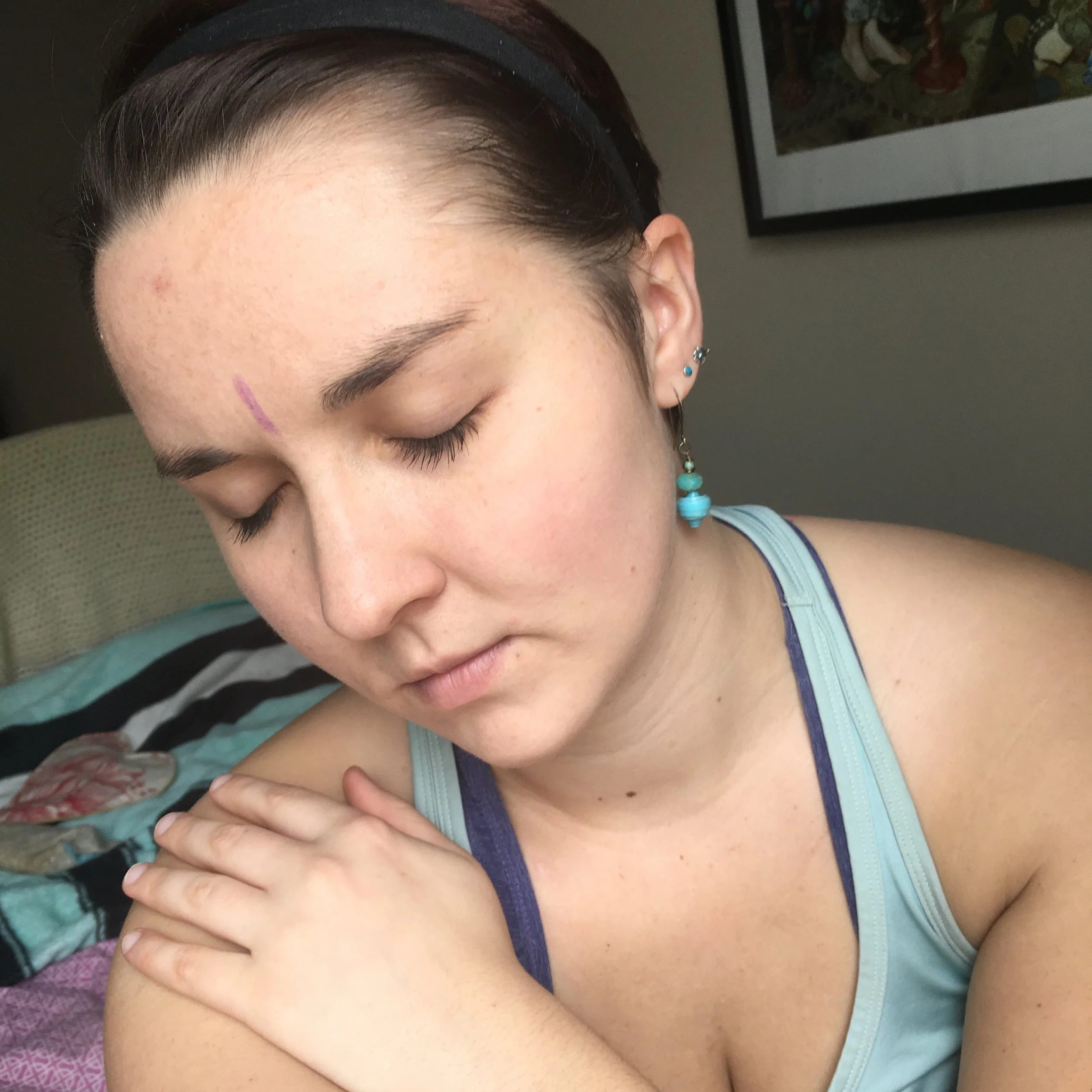 Giving myself some love after drawing on my third eye with a crayon - part of a self-love assignment from Crealitation Course One: the Magic of Difficulty.