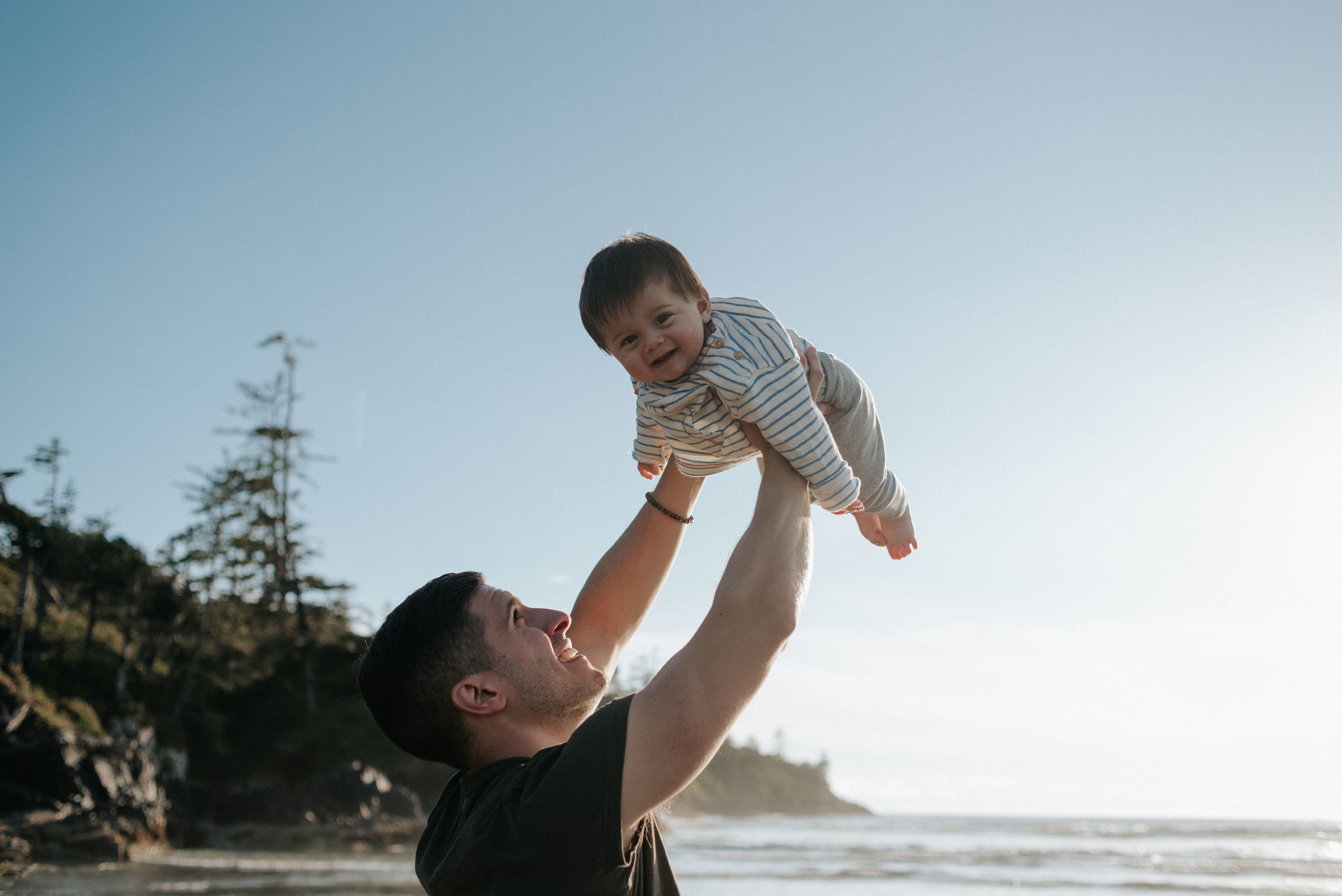 Young father with baby son at Cox Bay in Tofino