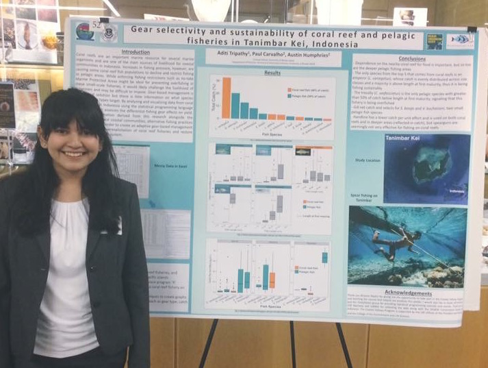 Aditi proudly standing with her poster at the Coastal Fellows symposium.