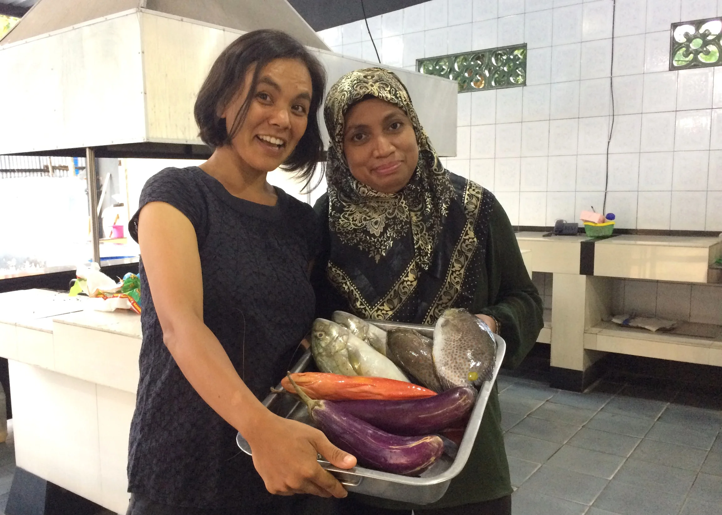 Melati and research collaborator Professor Wa Iba of Universitas Halu Oleo celebrate one year of successful data collection with a fish fry.
