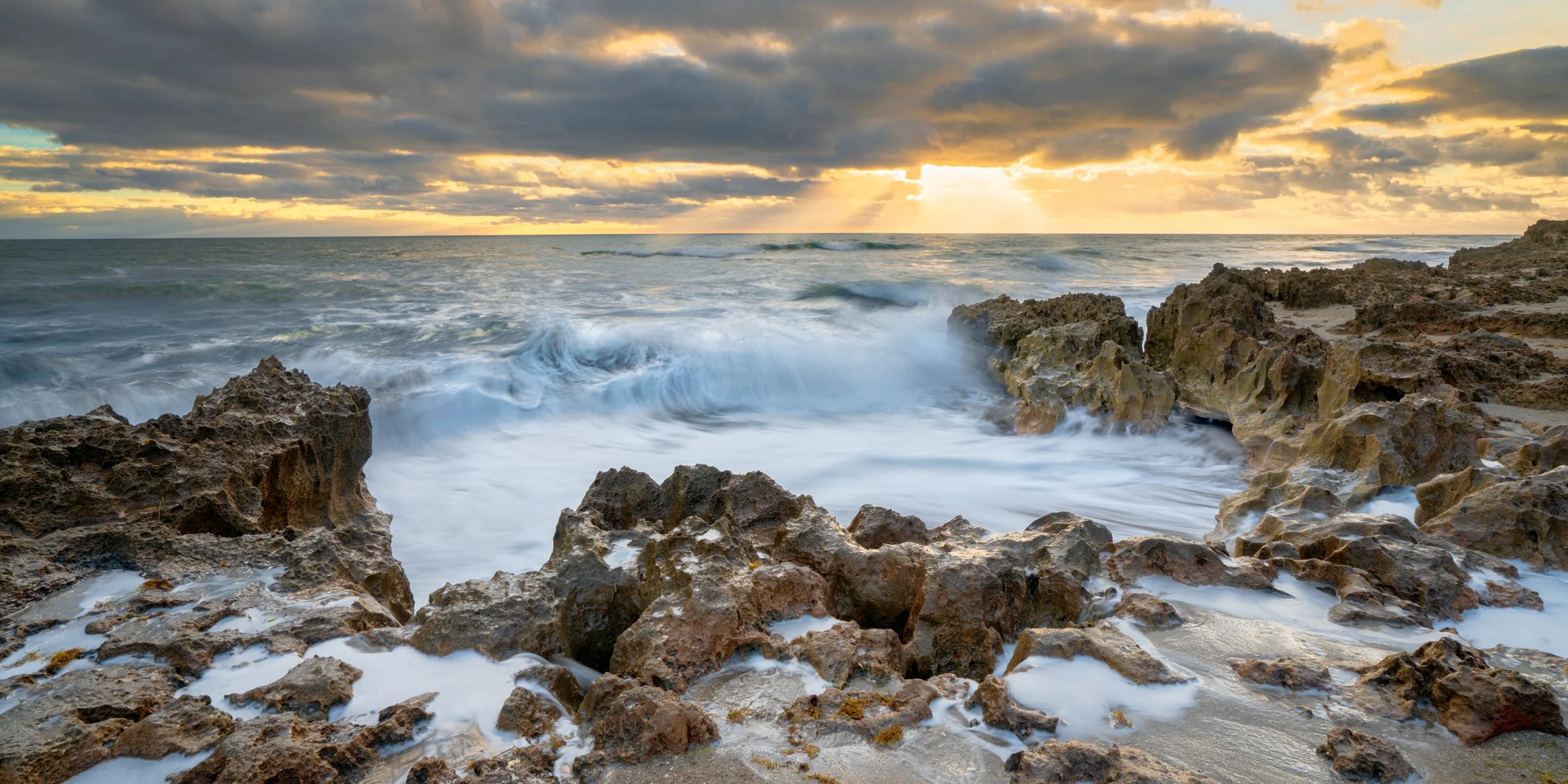 Florida beach sunrise photo with golden light beams