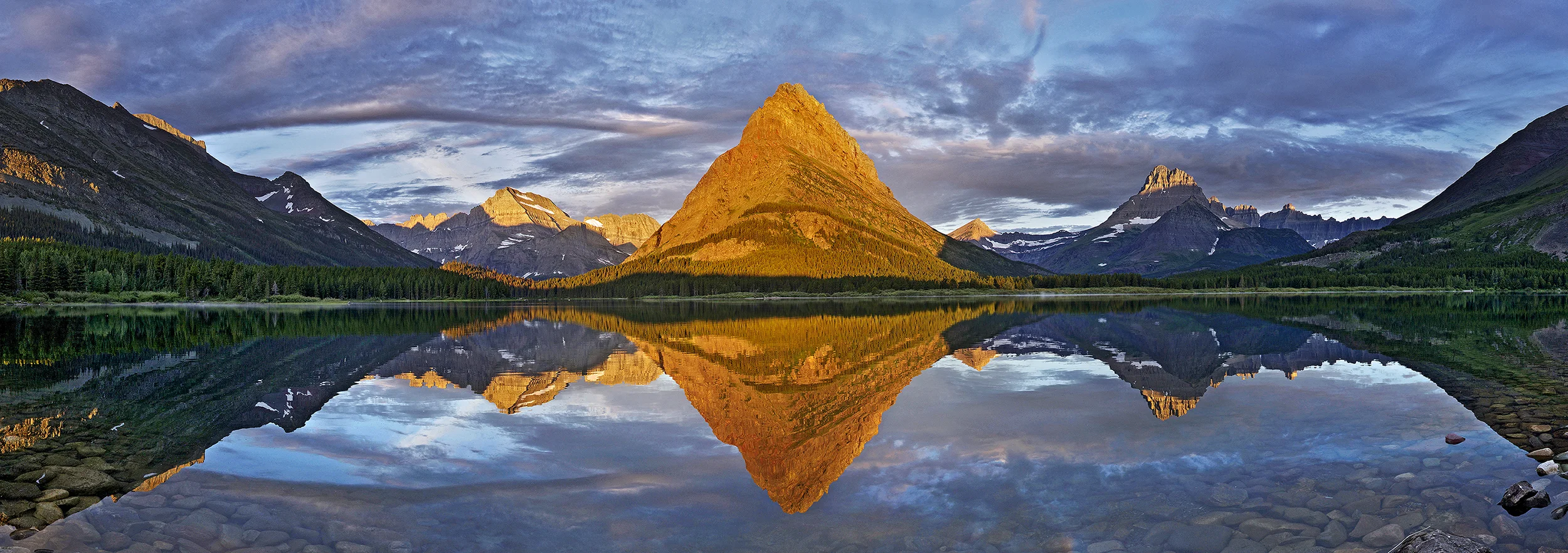 Panoramic Mountain Wall Art: Sunrise mountain scene with mirrored reflection and golden light on the peaks in Glacier National Park.