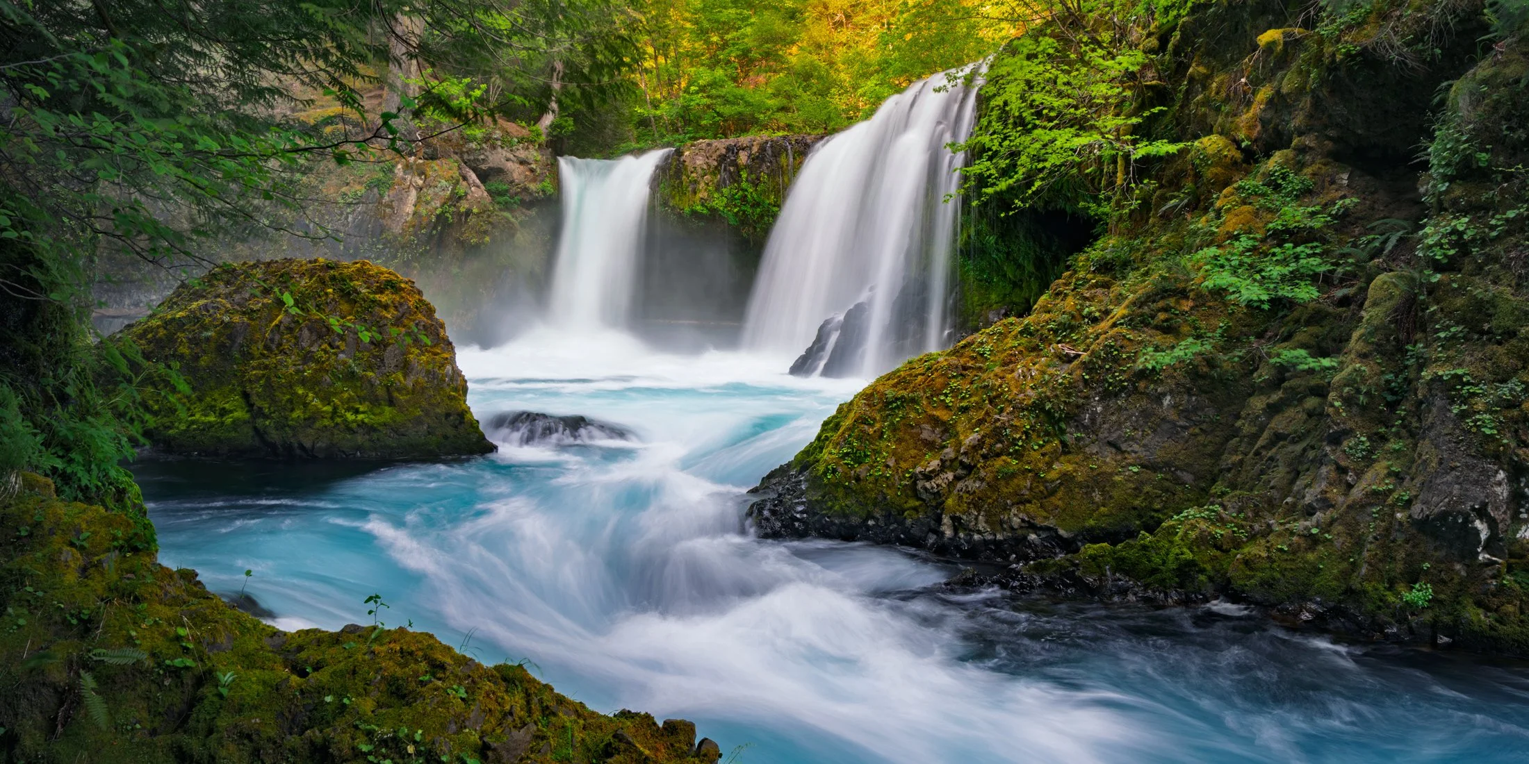 Spirit Falls waterfall landscape photo print for sale with vibrant blue water and green moss