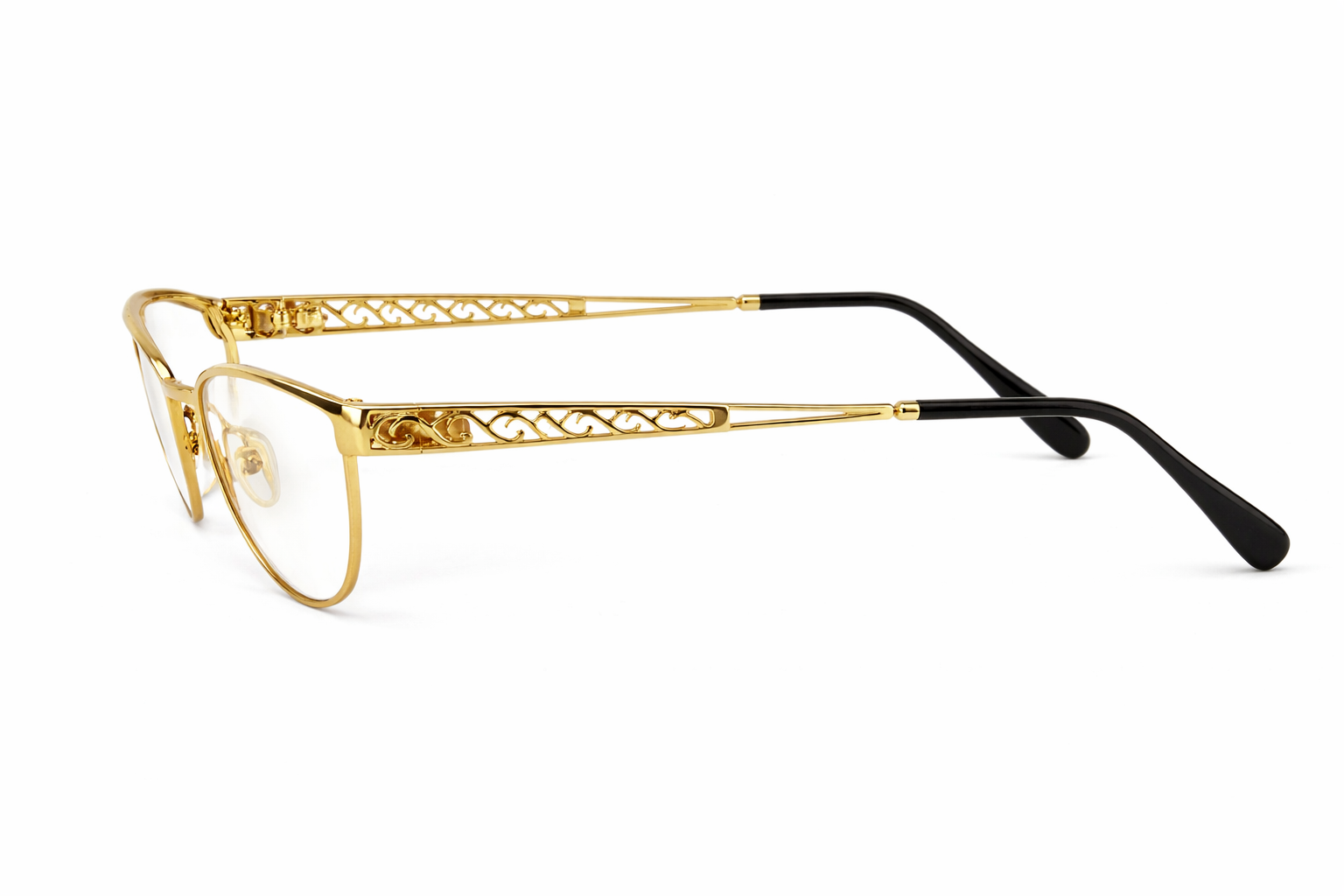 Elegant gold eyeglasses with intricate filigree.png