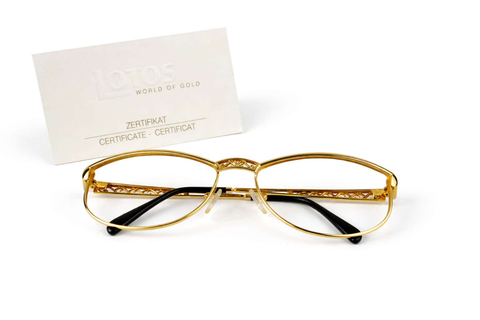 Gold-rimmed eyeglasses with certification card.png