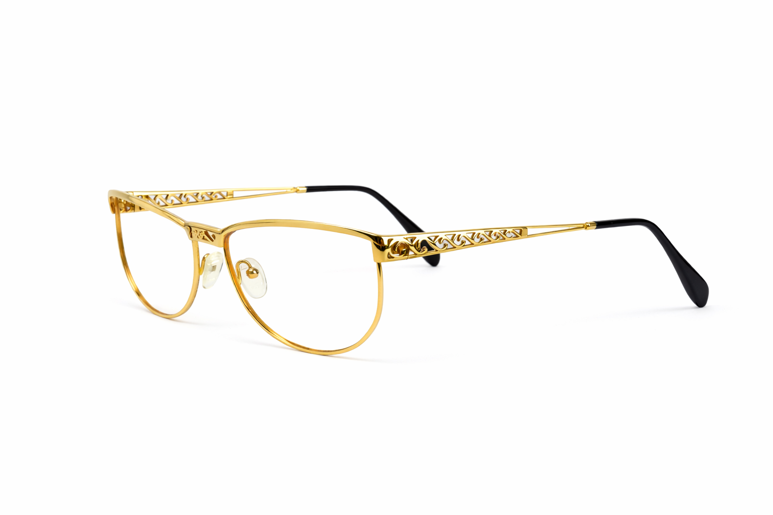 Gold-rimmed eyeglasses with filigree details.png