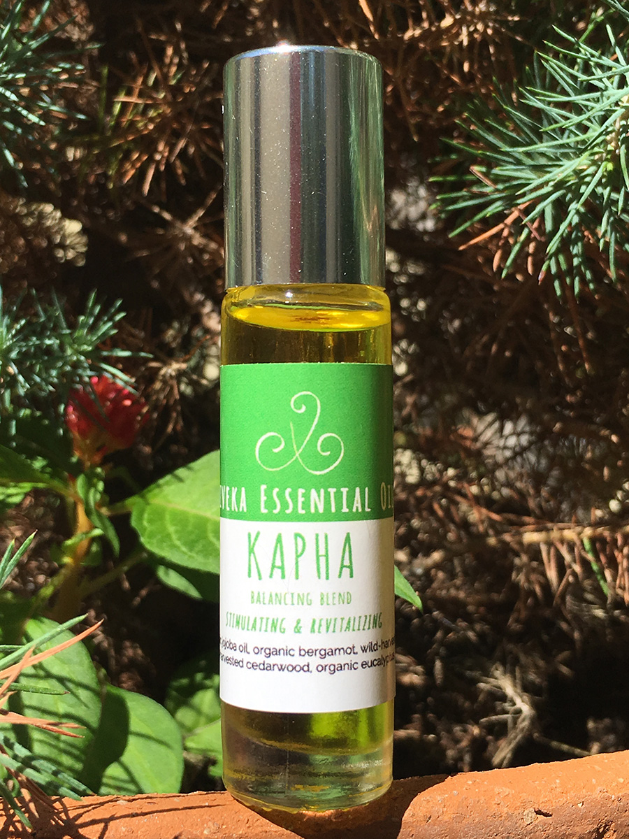 I find myself alternating right now between the Vata and Kapha balancing oils , because Vata/Fall season also brings about the first moments of wanting to hunker down and sometimes succumb to sluggishness. The qualities of Bergamot (uplifting), Tulsi (heart opening and boosts vitality) and Eucalyptus (promotes clear breathing and enhances the flow of prana), are nicely balanced with just enough Cedarwood to keep us grounded. Enjoy those two blends and let me know how they affect YOU!