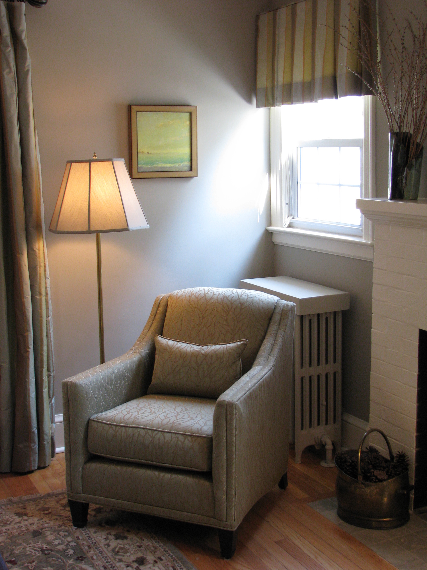 The warmth of the grey blue wall is a lovely backdrop for this oil by R. Michael Carr. 