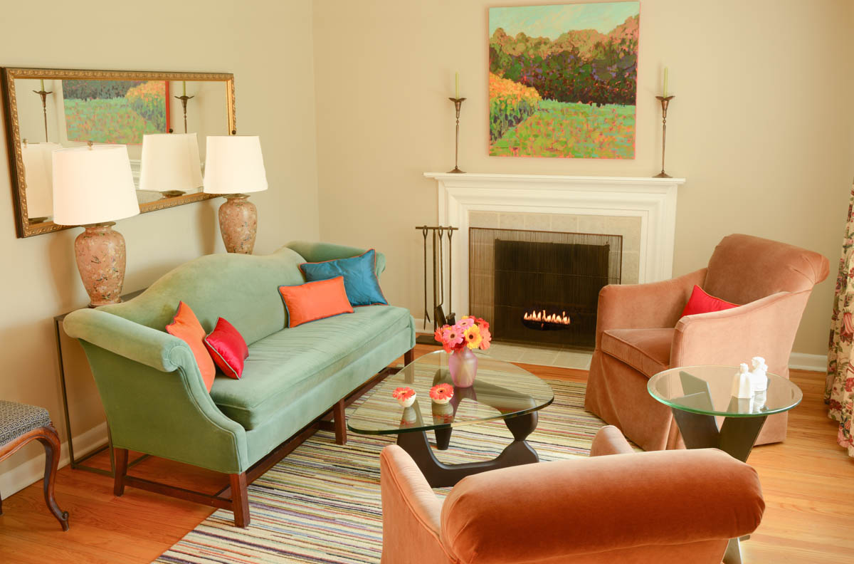 This painting by Lenny Moskowitz was a case of love at first sight. It almost magically unites and intensifies the colors of the room. The sofa remained the same, but the rich velvet chairs ground the room and add some depth, while the new silk pillows with contrasting welt pull out some of the colors from the painting.