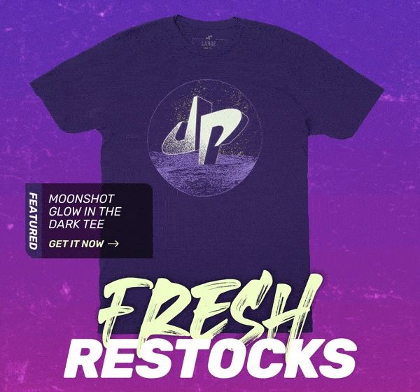 Black t-shirt with logo and text "Fresh Restocks" on colorful background. Featured: "Moonshot Glow in the Dark Tee."