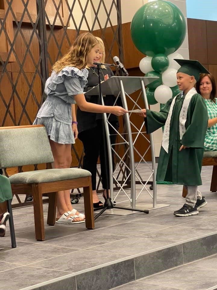   At the Meadowbrook School graduation ceremony, students are honored with character awards such as ‘Math Machine’ or ‘Kindest Friend’ in Michael’s legacy. Michael’s sister Emory, who turns 13 this year, stands a foot taller as she hands the certific