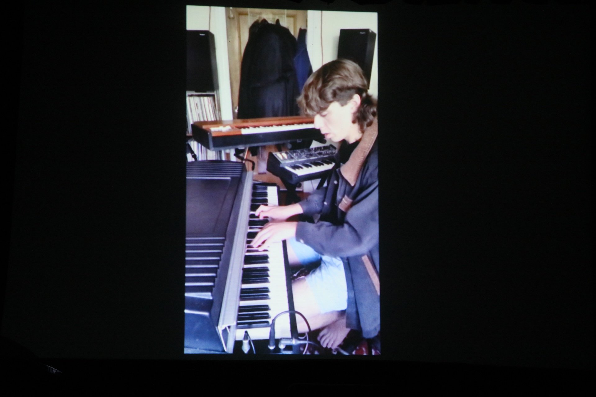 Joe Kaptein - message and performance. (photo from video shown during concert.)