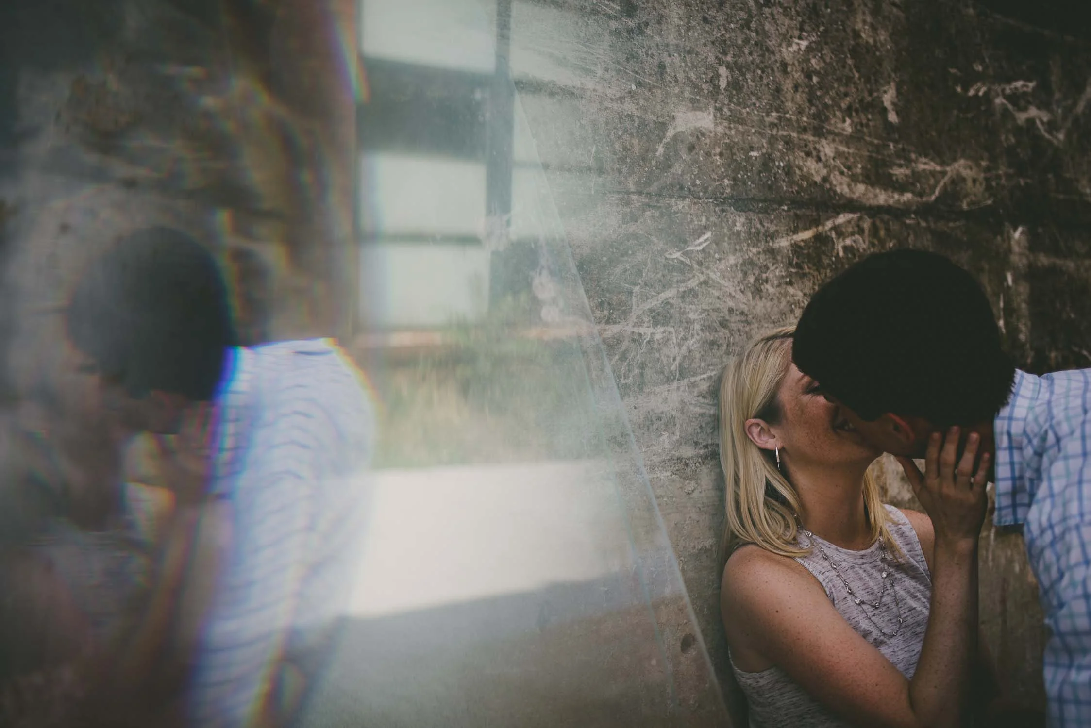 Couple share a kiss and a reflection, Durham, NC