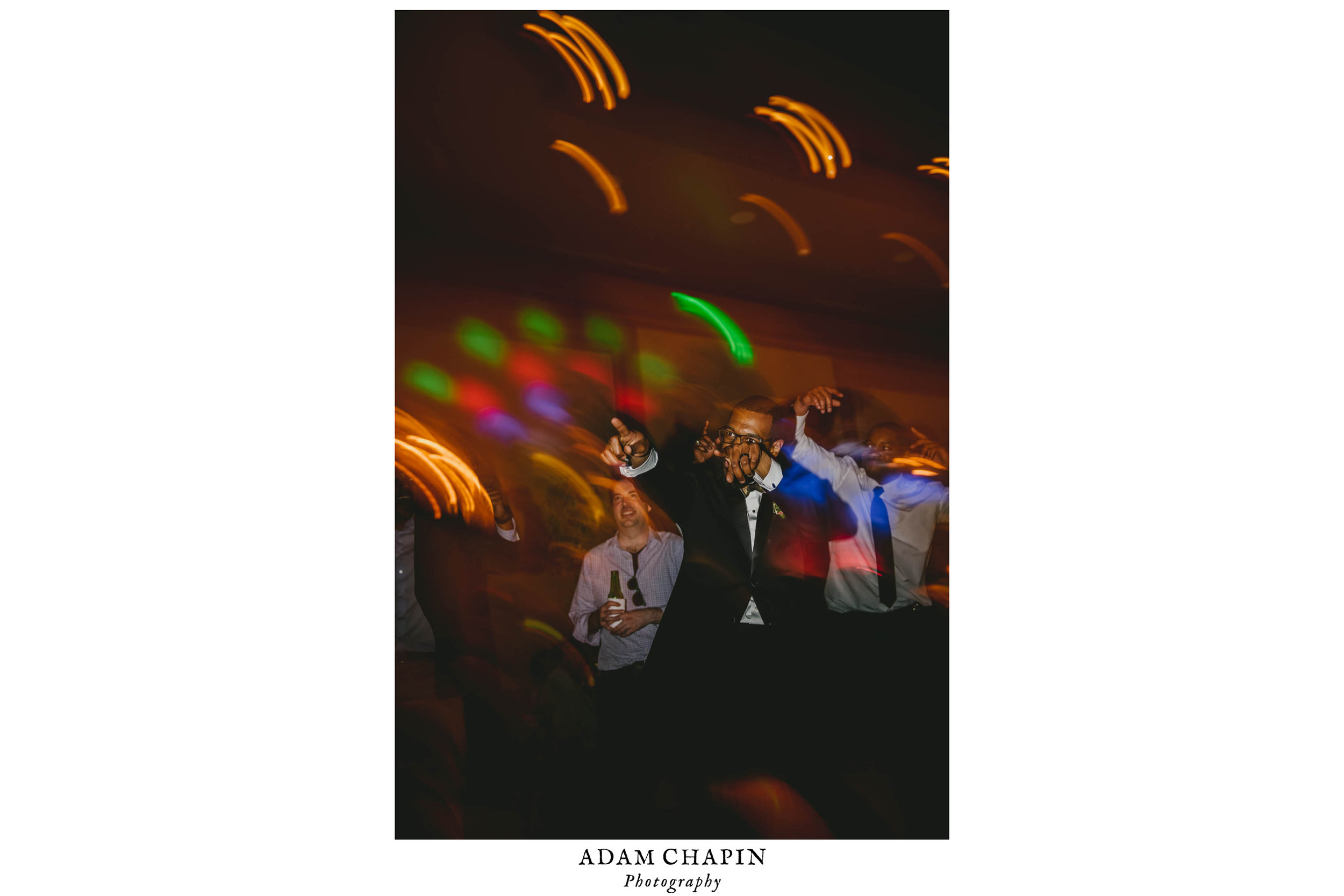 The groom dancing to the music during the reception