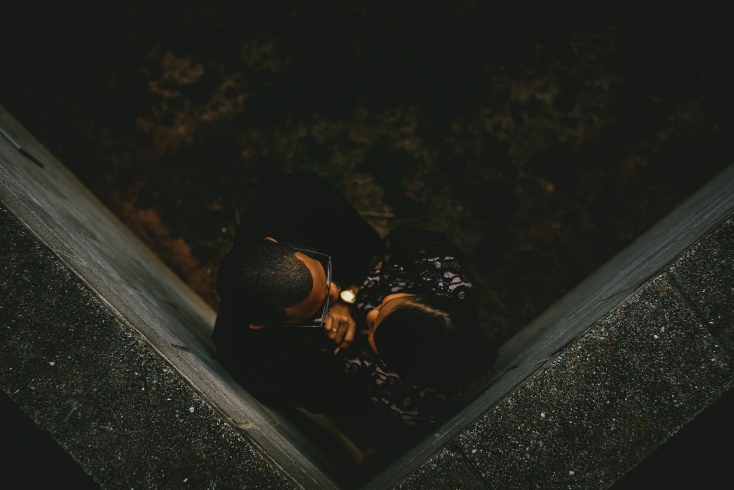 Overhead view of couple embracing during engagement photos at North Carolina Museum of Art