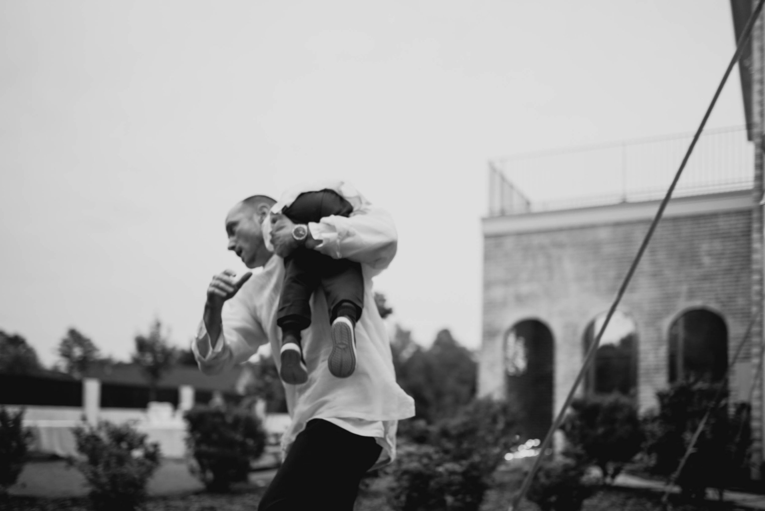 groomsmen playing with nephew during the wedding reception