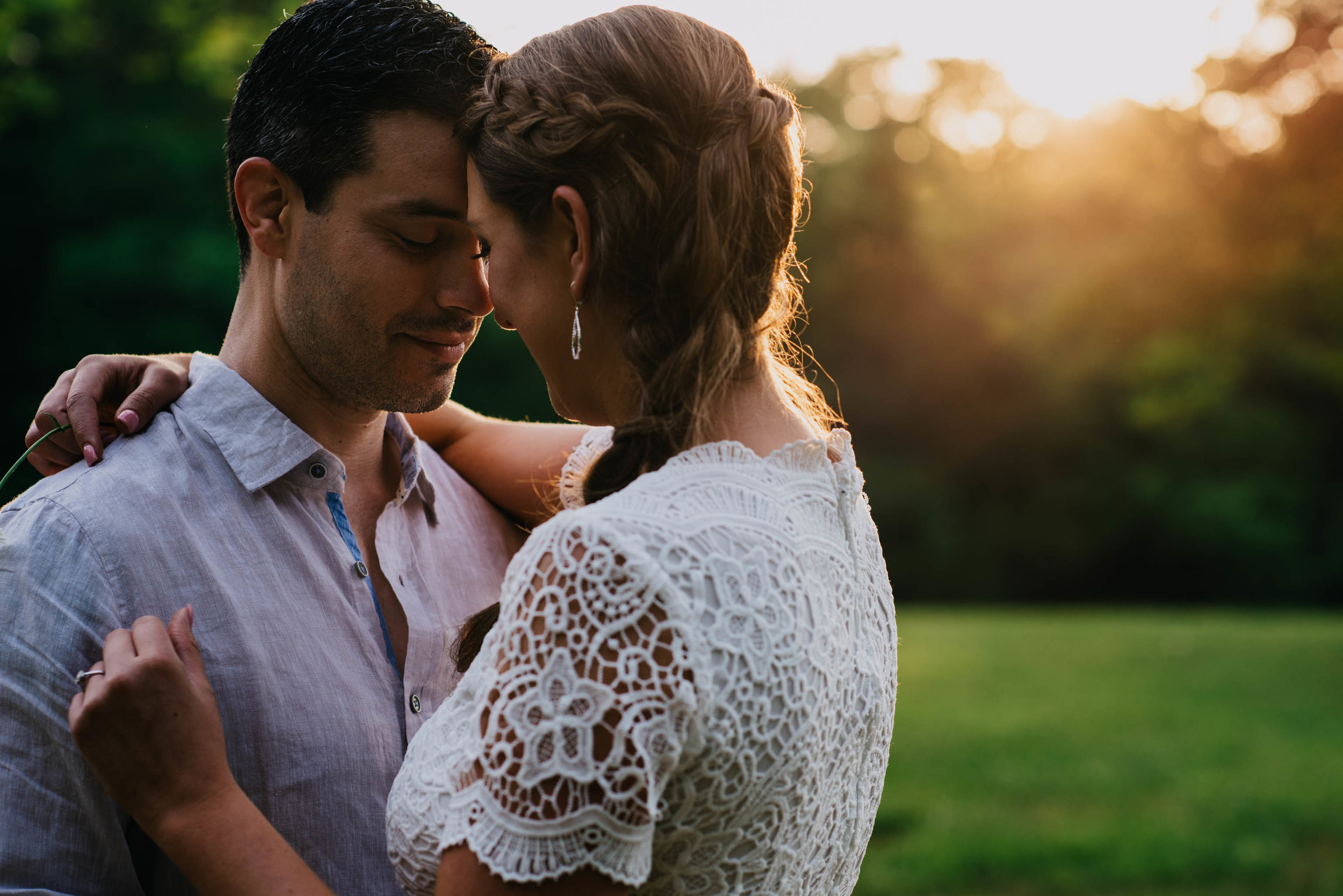 couple snuggling at Eno River Park during sunset