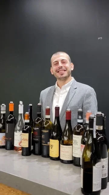 Italian wine expert Orazio Campoli at K&L Wine Merchants San Francisco, surrounded by wine bottles