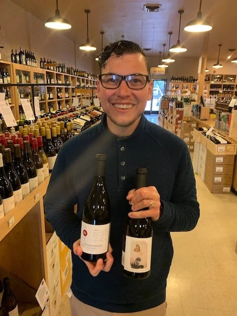Wine expert Alex Leonardini holding a bottle of wine.