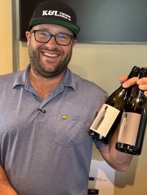 Wine Expert Ryan Woodhouse holding two wine bottles of Anonymous Wine Co.