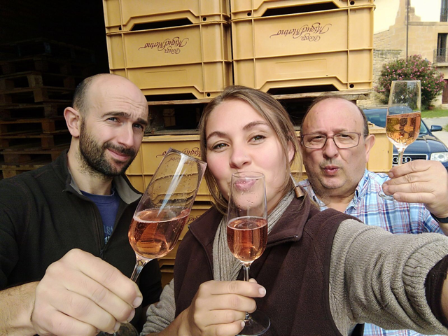 Three vineyard works toast the harvest with glasses of sparkling wine at Bodega Miguel Merino in Rioja.
