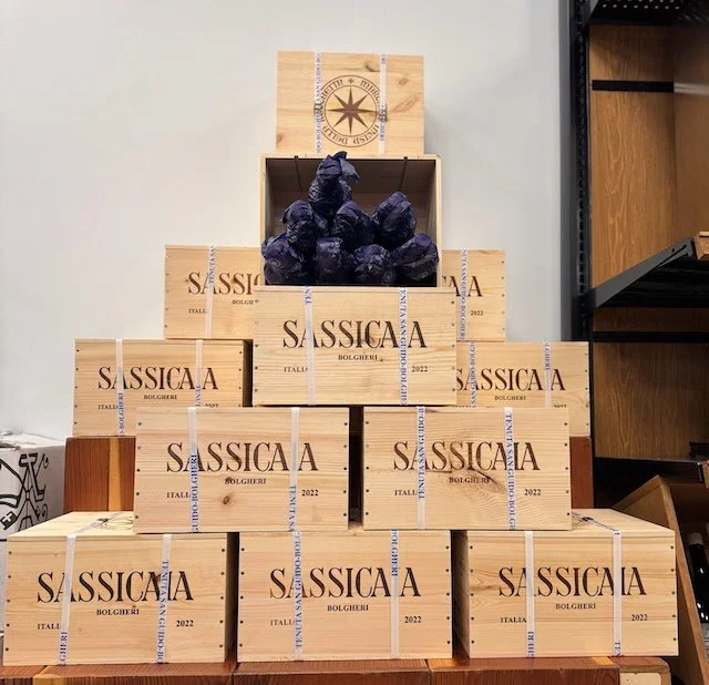 Wooden cases of Sassicaia Super Tuscan wine stacked at K&L Wine Merchants