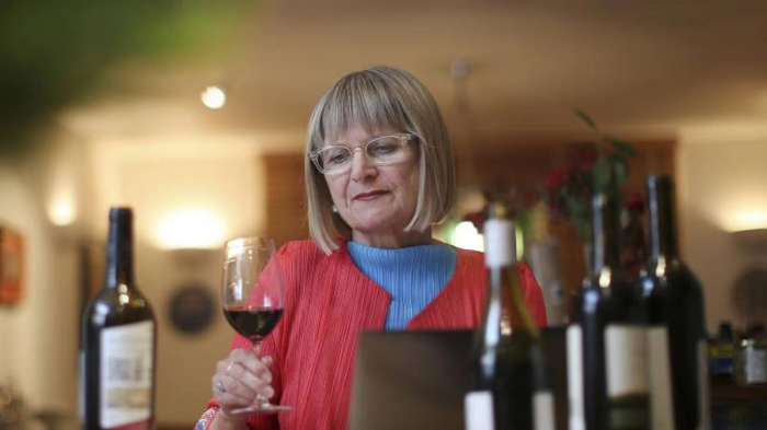 Famed Wine Critic Jancis Robinson holding a wine glass. K&L Wine Merchants is proud to be featuring several events with her this March.