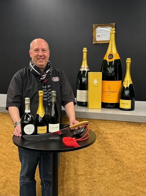 K&L Wine Merchants' Champagne Specialist with Laurent-Perrier, Krug, Franck Bonville, and Veuve-Clicquot. Plus a saber. He's getting ready for the Academy Awards.