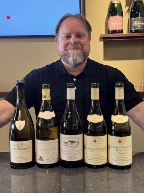 Burgundy Expert Alex Pross in front of 5 bottles of Burgundy