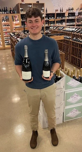 K&L Redwood City Champagne Specialist Graham Collins holding two bottles of the 2018 Billecart Salmon Anniversary Cuvee.