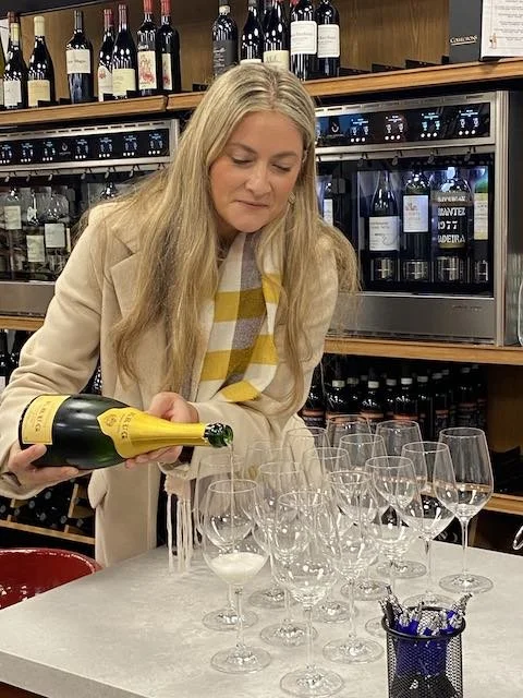 Champagne Expert pouring glasses of Krug Champagne