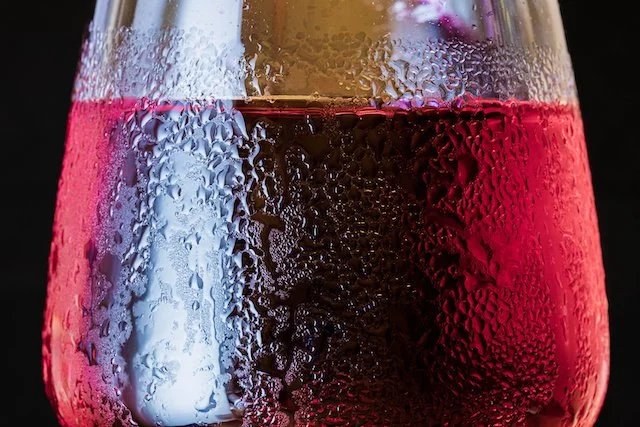 A chilled glass of light red wine with condensation—Spain's Garnacha, Graciano and Tempranillo are best served slightly chilled at 55–60°F in summer