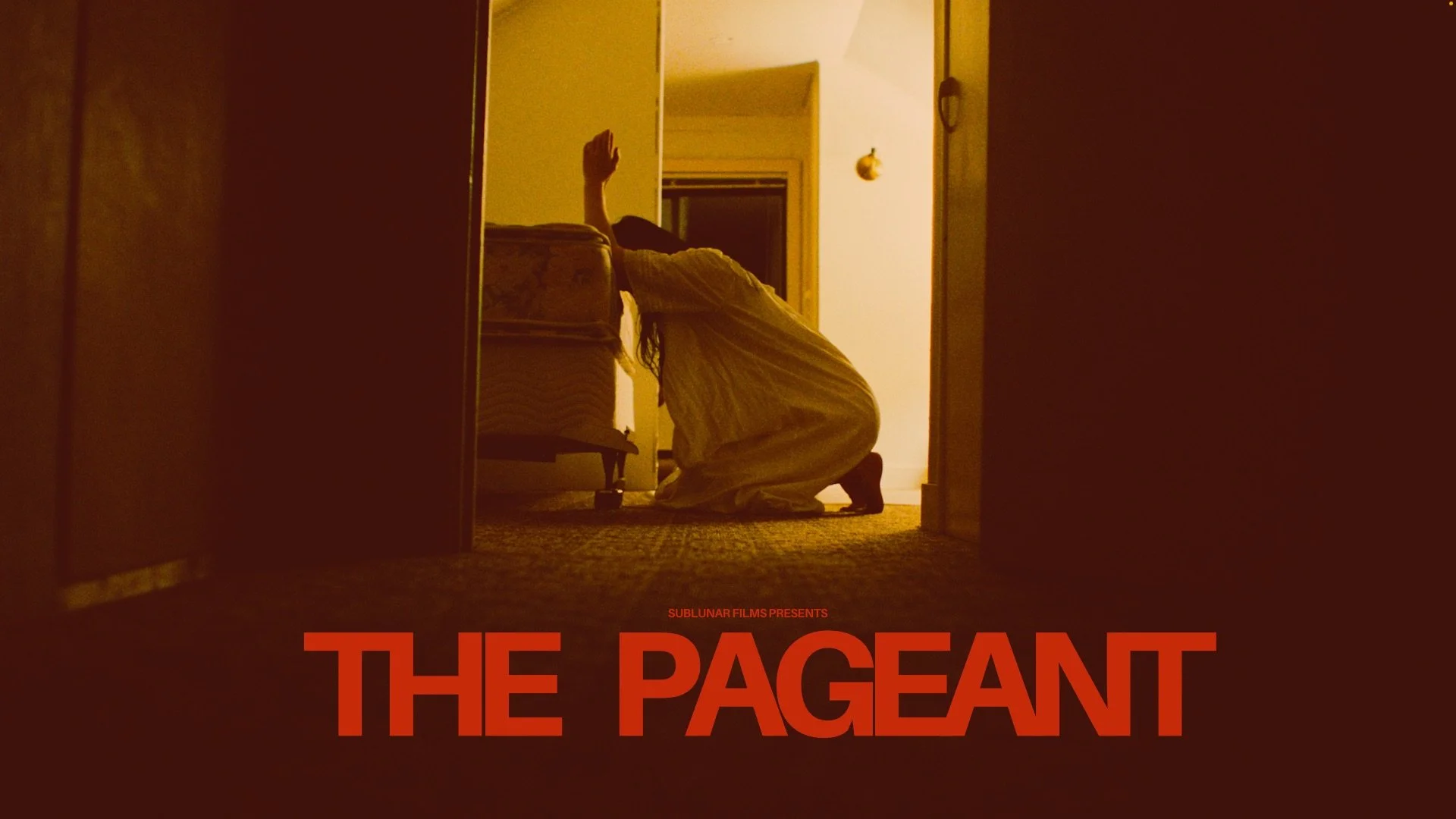 photo of a women kneeling on the ground beside a bed with her elbows on the bed.