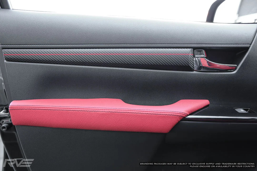 Armrest in red leather and black stitching.