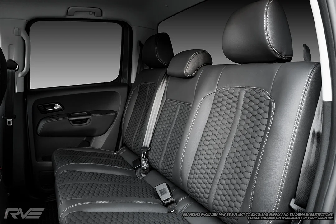 Upgraded Monza sport seats in OEM black leather with silver stitching and black stitched honeycomb inserts.