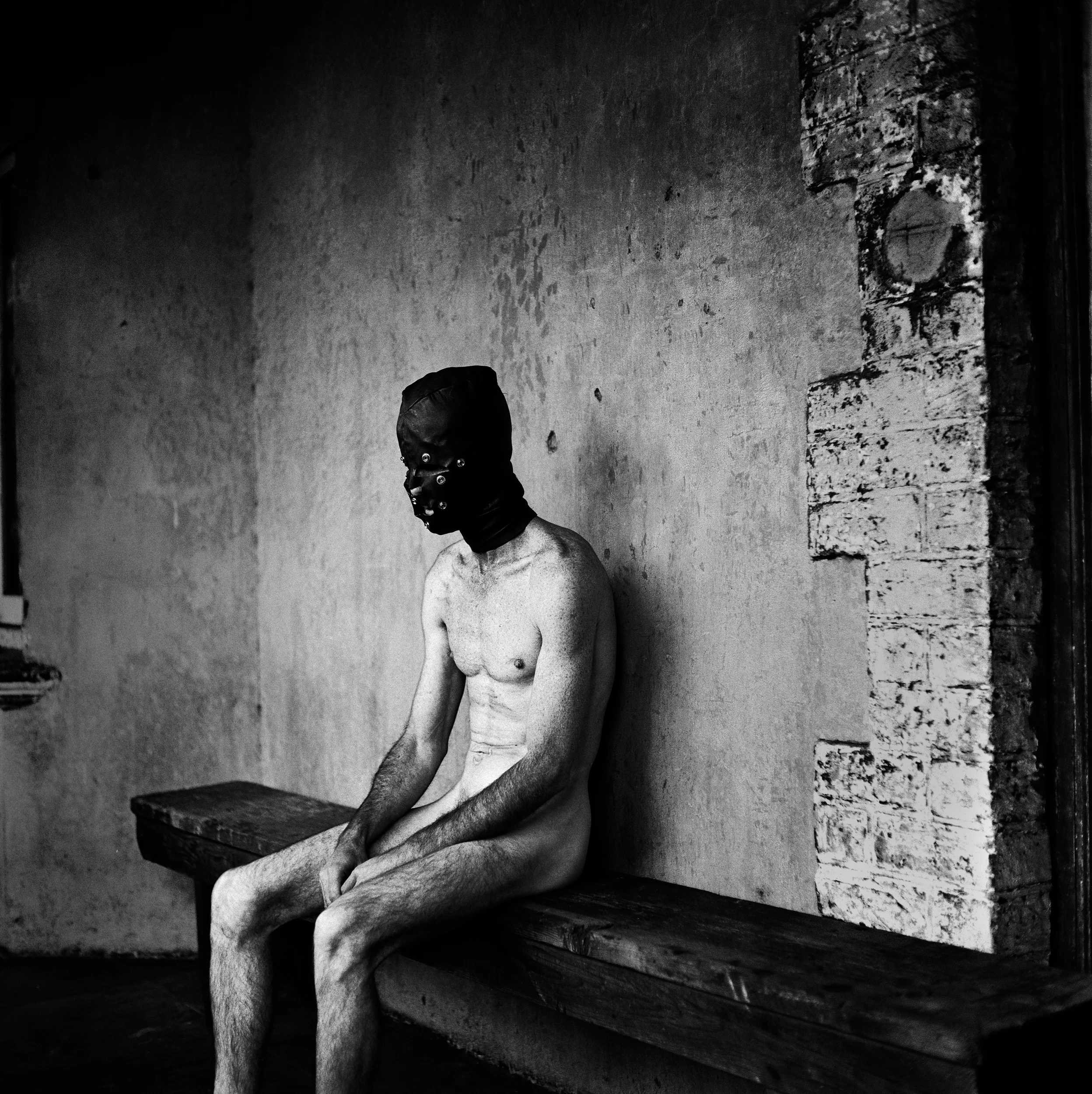JOHANNESBURG, SOUTH AFRICA-JANUARY 2002: A masked man recovers from a severe Sadism and Masochism session with his Mistress at a house in suburban Johannesburg. During this session he was whipped and burnt with a cigar. This is the only means by which he finds a sense of self-worth. PHOTO BY BRENT STIRTON/GETTY IMAGES