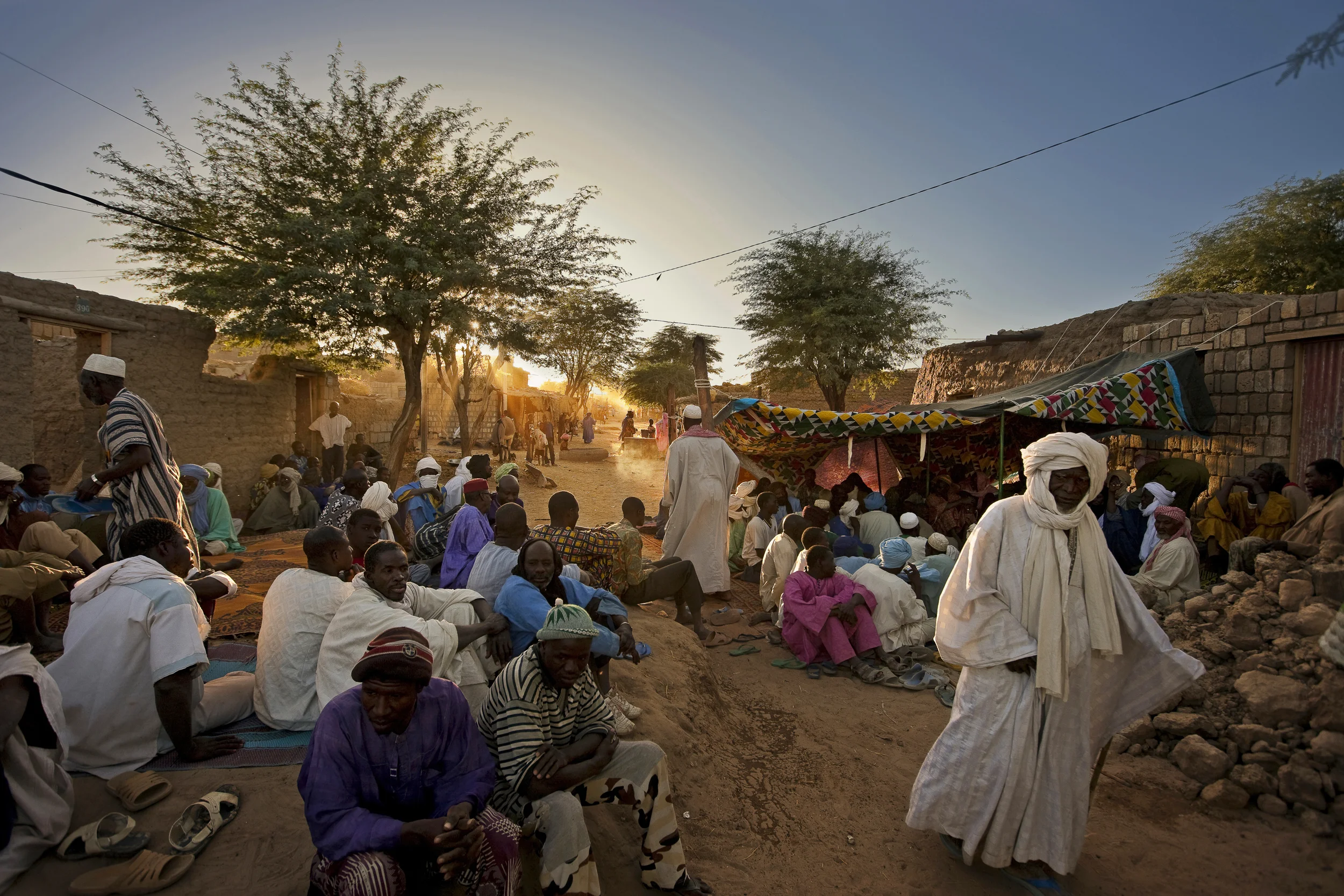 TIMBUKTU, MALI, JANUARY 2010: Late Afternoon scenes at a funeral in the streets of Timbuktu, MALI, 5 JANUARY 2010. Funerals in Timbuktu are conducted separately, with the woman mourning inside the house of the deceased and the men outside on the street involved in prayers and remembrance in the Islamic tradition. (PHOTO BY BRENT STIRTON/NATIONAL GEOGRAPHIC.)