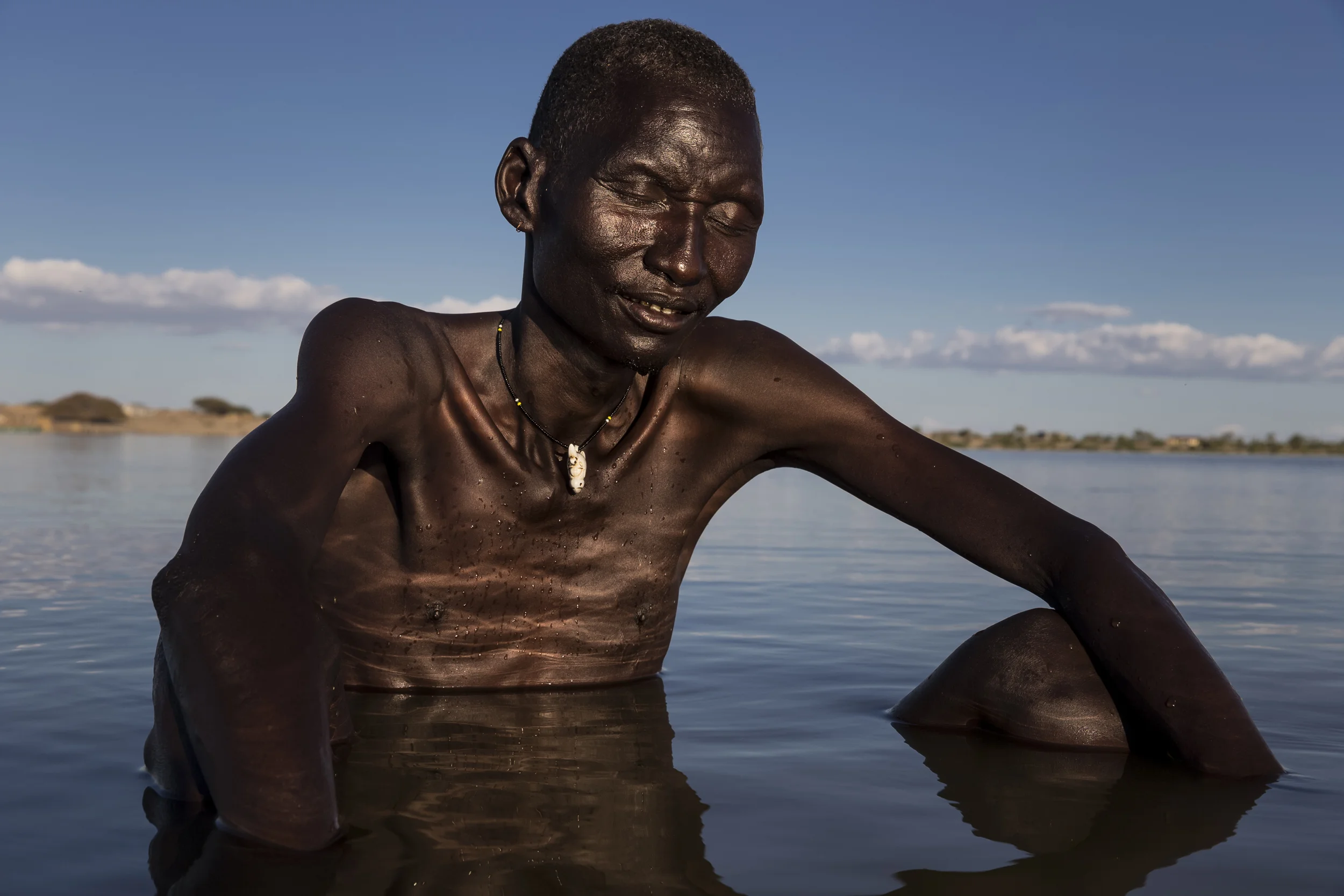 TURKANA, KENYA, 8 OCTOBER 2014: Scenes from Longetch fishing village on the shores of Lake Turkana, Kenya, the world's largest inland desert lake. This region of the lake is a well know spawning ground and at the heart of fishing commerce for the Turkana. These villagers along with many thousands along the shores of this vast body of water are soley dependent on the lake for their survival. The Turkana are traditionally pastoralists but persistent droughts have decimated their herds to such an extent that for many Turkana fishing is now their main means of subsistence and commerce. The same pattern is emerging for other tribes along the lake shore. Recent dam building in Ethiopia is likely to bring the Omo river to one fifth of its current flow, sugar cane farms along the Omo are already causing tribal movement down to Lake Turkana as pastoralists struggle for grazing and water rights. The Omo river supplies 90% of Lake Turkana's water and these dams and sugar cane farms look likely to severly impact the renewal of the lake's waters. This threatens all the tribes around the lake and makes conflict over diminishing resources ever likely. (Photo by Brent Stirton/Reportage by Getty Images for Human Rights Watch.)