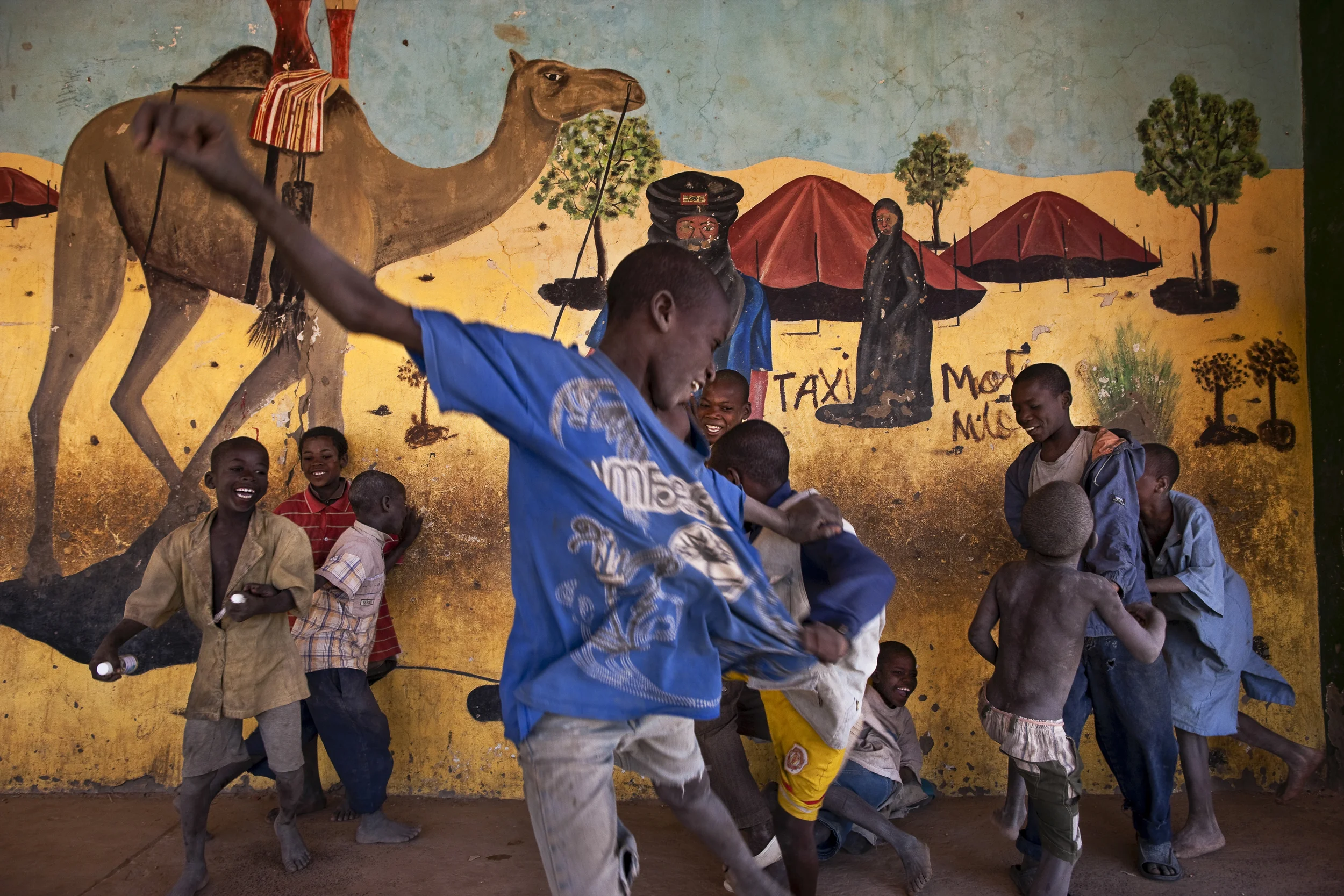 TIMBUKTU, MALI, JANUARY 2010: Boys play soccer near a Tuareg desert mural in the center of Timbuktu, the mythical Northern Mali city, 22 January 2010. (Photo by Brent Stirton/Reportage by Getty images.)
