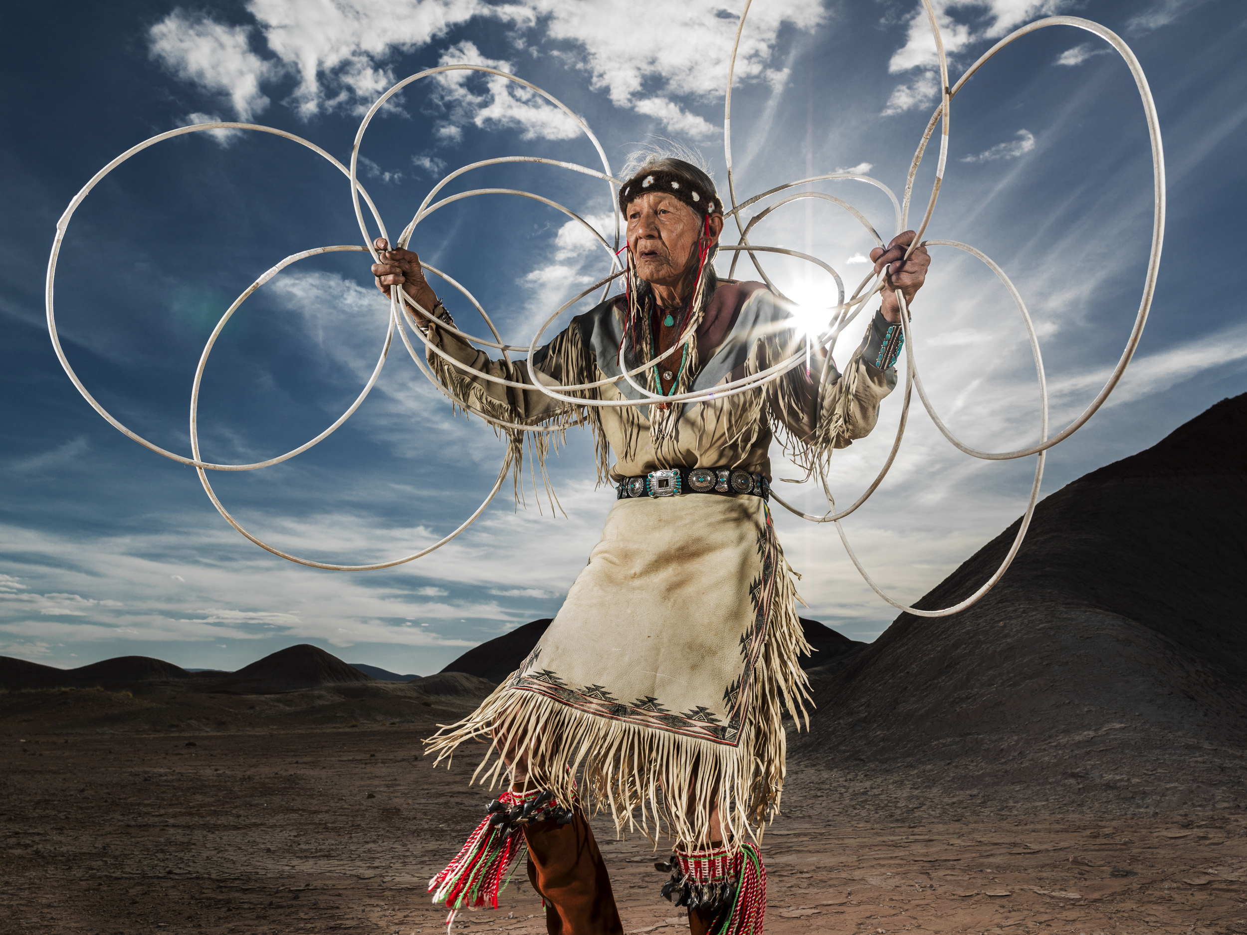 CAMERON, ARIZONA, 16 APRIL 2014: Jones Benally, a famous medicine man, dances the Navajo Hoop dance in a small canyon in the badlands of Cameron, Arizona. The hoop dance is traditionally performed at the end of a grueling nine day ceremony and is a