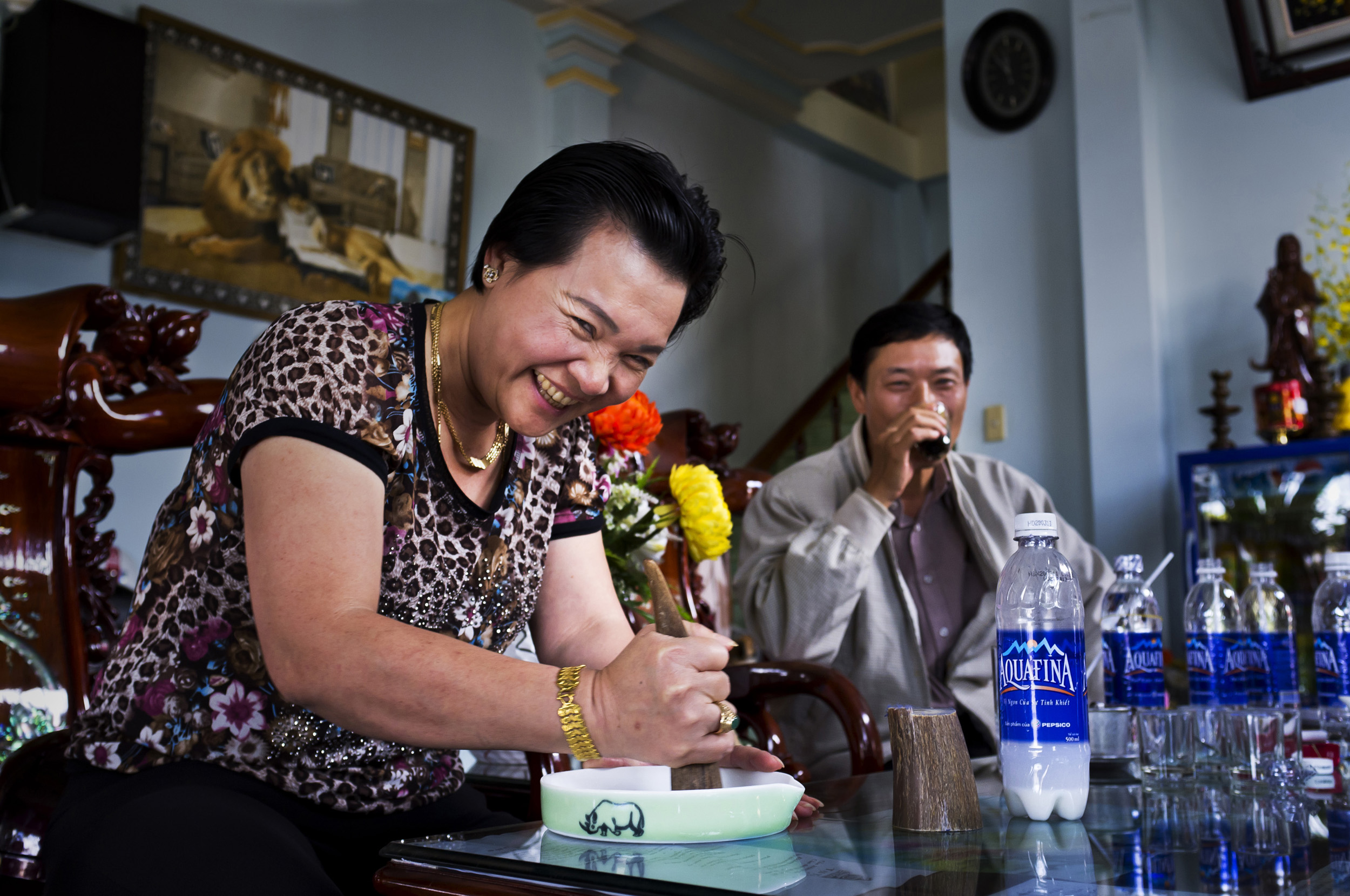 Baoloc, Vietnam, 6 October 2011: A wealthy Vietnamese woman sits and grinds Rhino horn for her personal consumption in a roadside café in Baoloc, Vietnam. The dealer who sold her the horn sits next to her. Rhino Horn is an illegal substance in Vietn