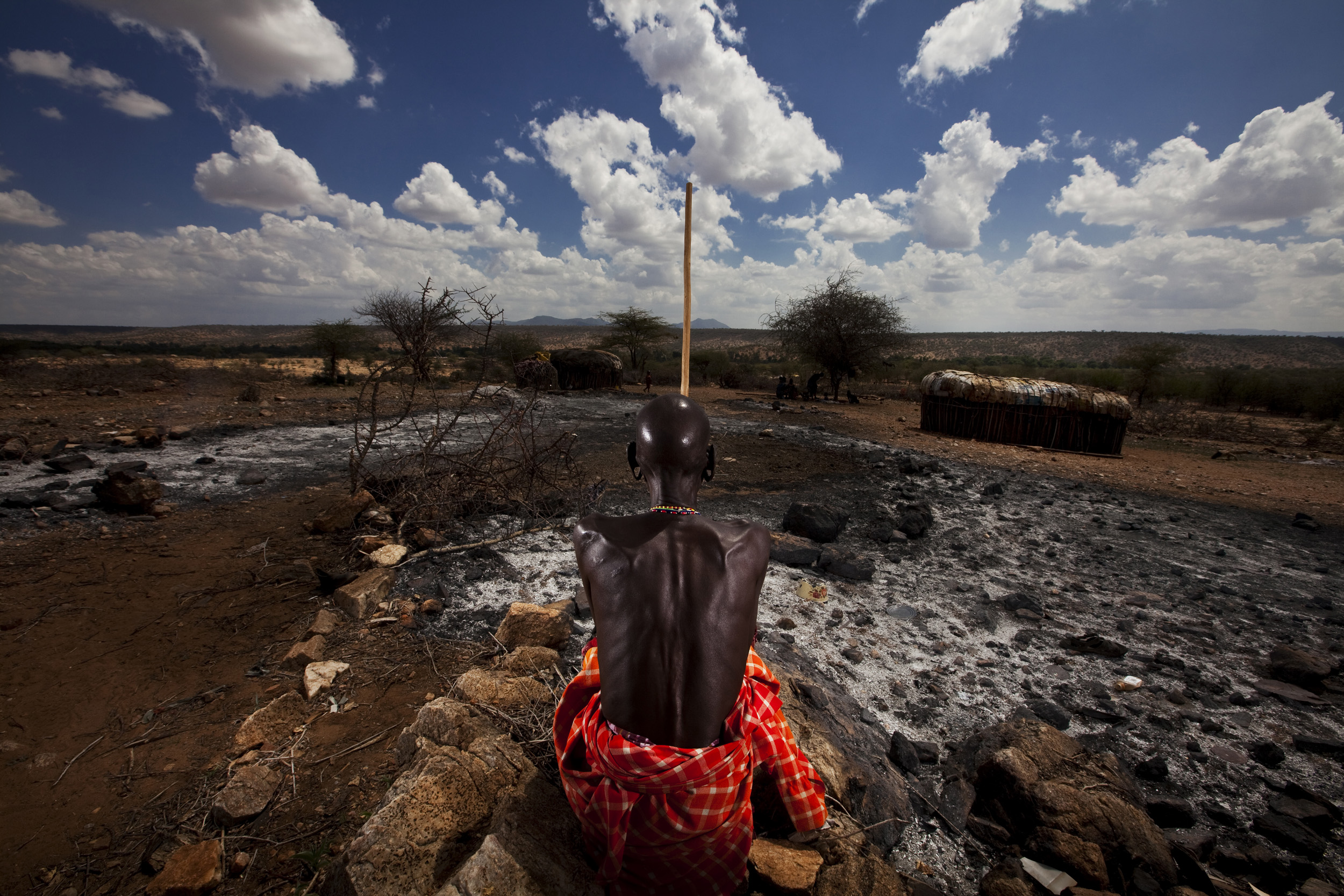 RIFT VALLEY PROVINCE, KENYA, NOVEMBER 2009: An emaciated Samburu Elder pastoralist stands in his burnt-out cattle boma at at time of the worst drought in Kenya for the last 100 years, 20 November 2009. It is traditional for the Samburu and other pa