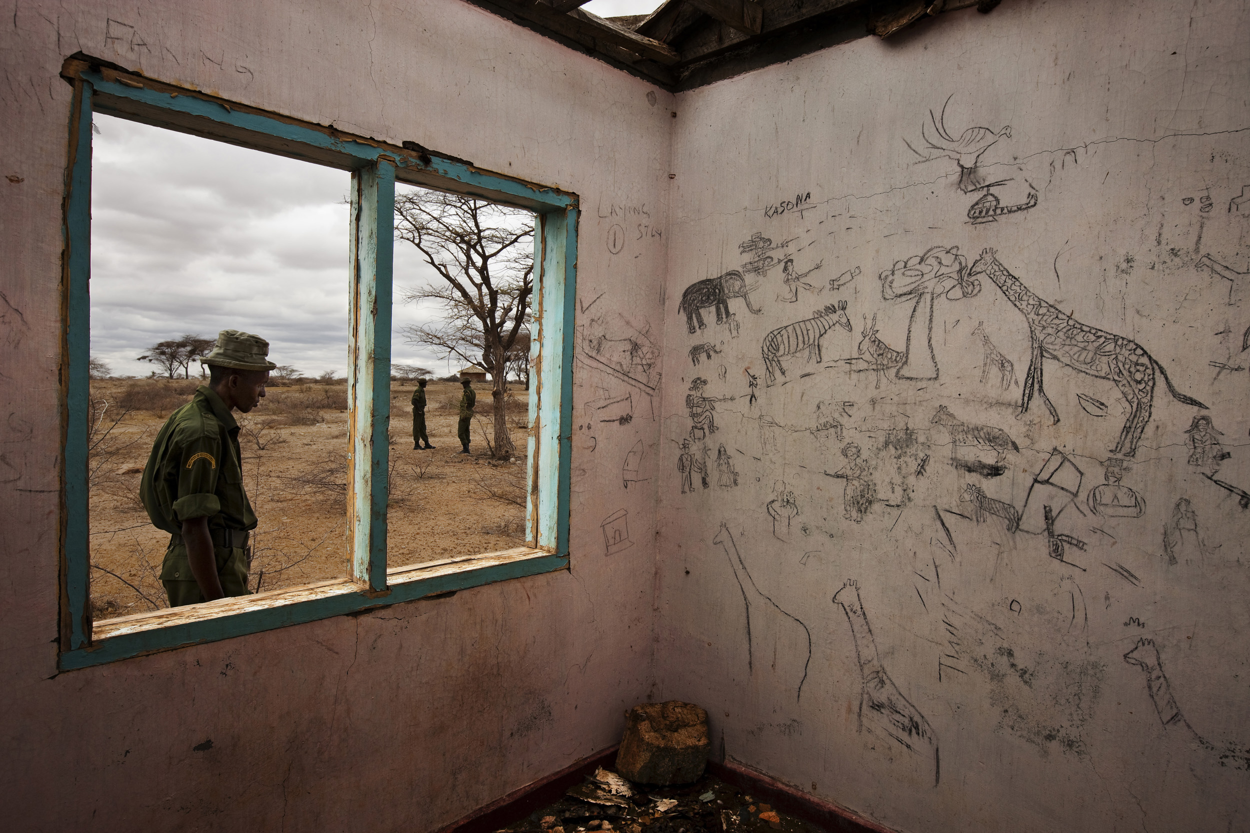 KOYA, MARSABIT SOUTH, NORTH KENYA: Melako Conservancy Scouts patrol around abandoned buildings in Koya, an area which became a vast no mans land after extensive cattle raiding between the Rendille tribe and the Borana tribe, Koya, north Kenya, 28 Fe