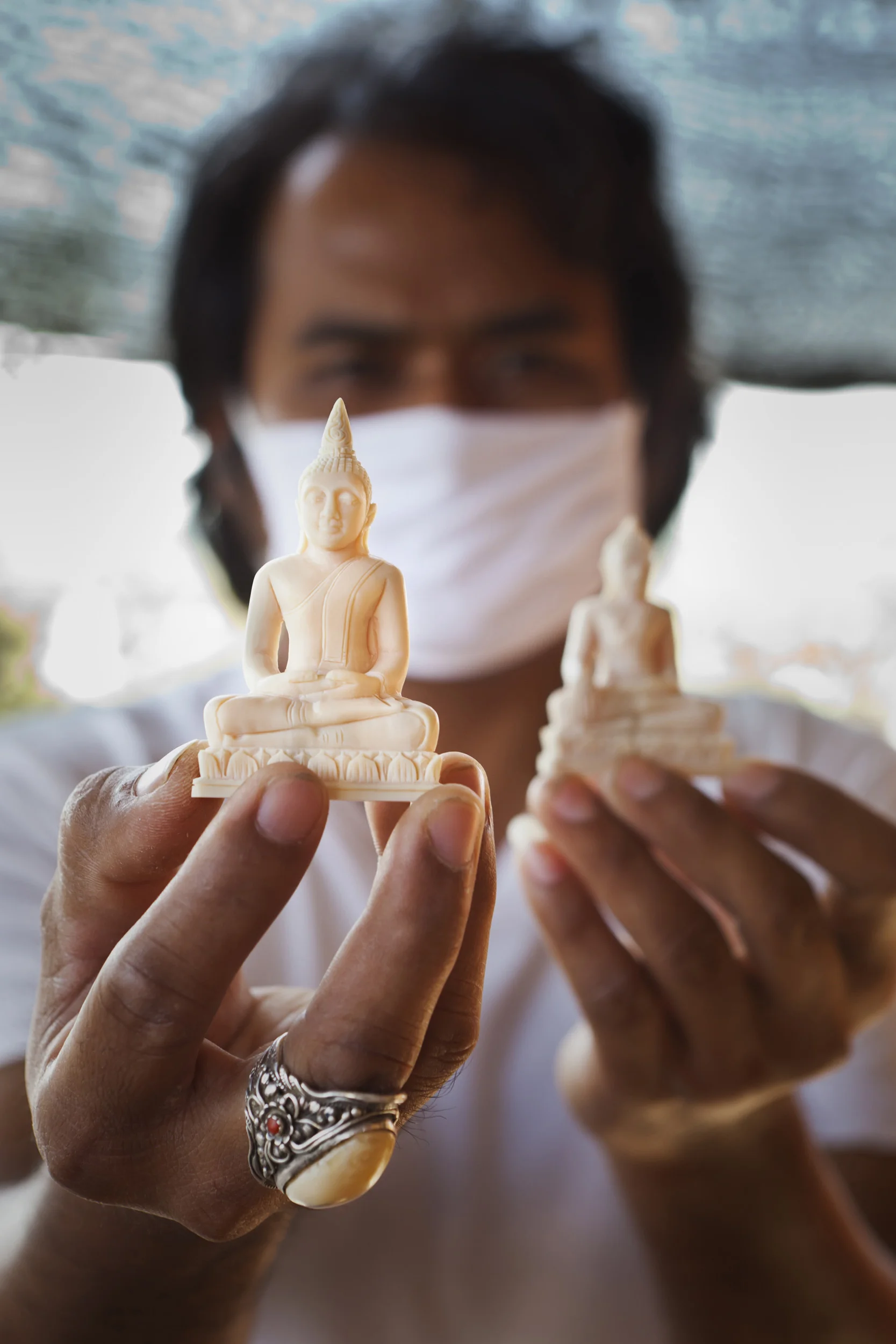SURIN, THAILAND, NOVEMBER 2011: Mr Ramet Yeerum, 34, a master ivory carver at work in a small village close to Surin Elephant Village in Surin, Thailand, November 10th, 2011. Mr Yeerum stated that most of his clients are Monks who buy his Ivory carvings of Bhudist icons for resale purposes. He estimates that the vast majority of his business is the carving of these religious pieces. He commented openly on the presence in Thailand of illegally imported African ivory and how to get it into Thailand past customs authorities. He also spoke of how senior memember of the Thai parliment are behind the illegal industry. He further offered his services as a carver in Africa if we could get him there. The Thai legal system has many loopholes as a result of the domestic ivory situation and Thailand is suspected of being a major transit country for illegal African ivory as a result. (Photo by Brent Stirton/Reportage for National Geographic Magazine.)