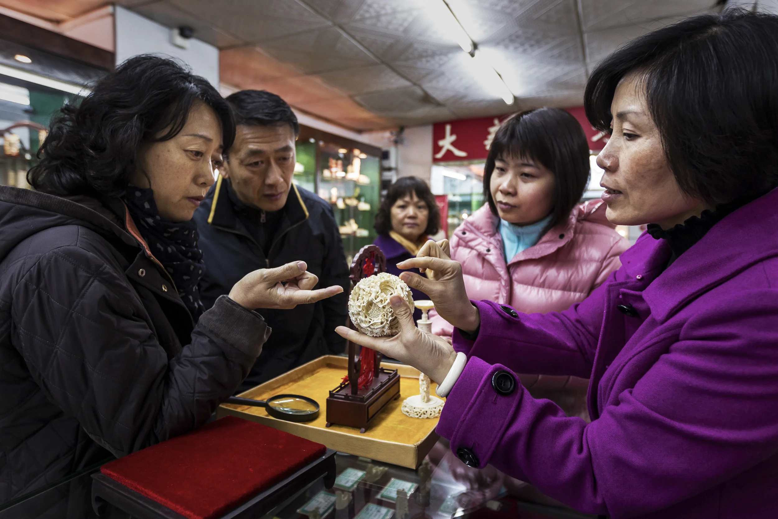 GUANGZHOU, CHINA, FEBRUARY 2012: Images of Ivory shoppers at the Guangzhou Daxin Ivory Carving Factory retail store, Daxin is the only state owned enterprise specialising in the ivory carving businessin the People's Republic of China, Guangzhou, February 4 2012. On this occasion a Chinese man and woman purchased 15 seperate items, spending over 100 000 RMB, over $16000. The store manager says that this is not unusual. This customer was not from Guangzhou and had come specifically to purchase Ivory for his new home and for gifts. Ivory is seen as symbol of wealth and an affirmation of prosperity amongst the Chinese. No other nation in the world has experienced such an growth of wealthy individuals as China. As a result the demand for Ivory continues apace, with potentially disastorous consequences for the elephant. (Photo by Brent Stirton/Reportage for National Geographic Magazine.)