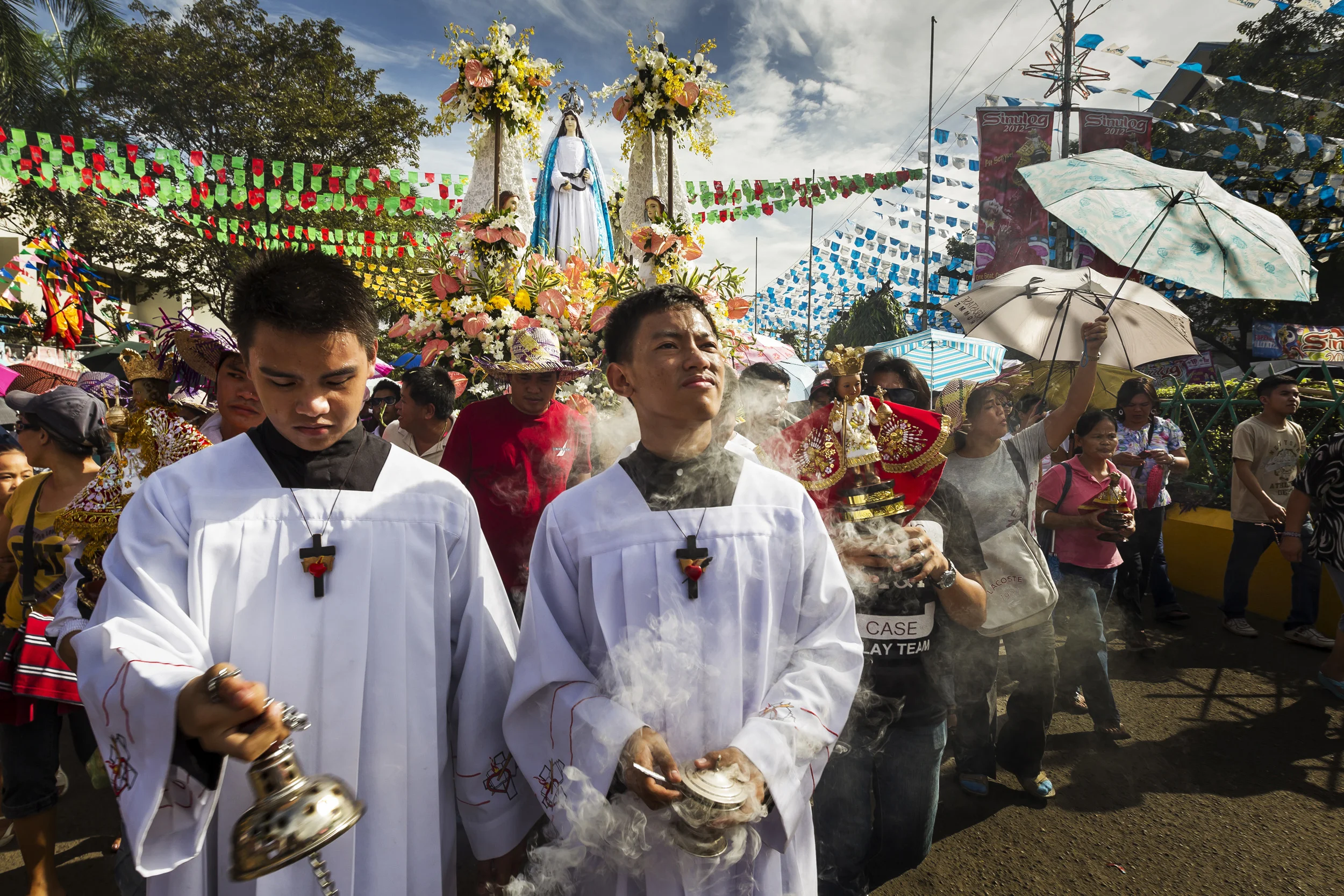 CEBU, PHILIPPINES, JANUARY 2012: The "Walk with Mary," procession in Cebu, Philippines, 13 January 2012. The "Mary" seen on the float is Our Lady of Guidance, traditionally housed in the Basilica Minore del Santo Nino in Cebu city and she is made of Ivory. This substance has long been used in religious circles for statues and carvings of important icons across all the major religions in a practise that continues today. This devotional walk is part of the Sinulog festival, a larger celebration largely devoted to the Santo Nino, a 15th century religious icon portraying Jesus Christ as an infant, originally brought to Cebu by Ferdinand Maggelan in 1521. There are a large number of Ivory carved Santo Nino's in existence too. Many are owned by private collectors who collect them with some fervour, others are housed behind glass in churches where devotees will often touch the glass or rub material on the glas in order to receive the blessing of the Icon. Ivory has long been a high end material for the creation of these religious pieces. Historical accounts say that before Portuguese navigator Ferdinand Magellan came to Cebu on April 7, 1521 to plant the cross on its shore and claim the country for the King of Spain, Sinulog was already danced by the natives in honor of their wooden idols and anitos. Then Magellan came and introduced Christianity. He gave the Santo Nino (image of the Child Jesus) as baptismal gift to Hara Amihan, wife of Cebu’s Rajah Humabon who was later named Queen Juana. At that time, not only the rulers were baptized but also about 800 of their subjects. Unfortunately, however, shortly after the conversion, Magellan went into a reckless adventure by fighting the reigning ruler of Mactan, Rajah Lapulapu, with only a handful of men. He died in the encounter. That was on April 27, 1521. The remnants of Magellan’s men were able to return to Spain to report the incident and the possibility of conquest. It took 44 years before a new group came and starte
