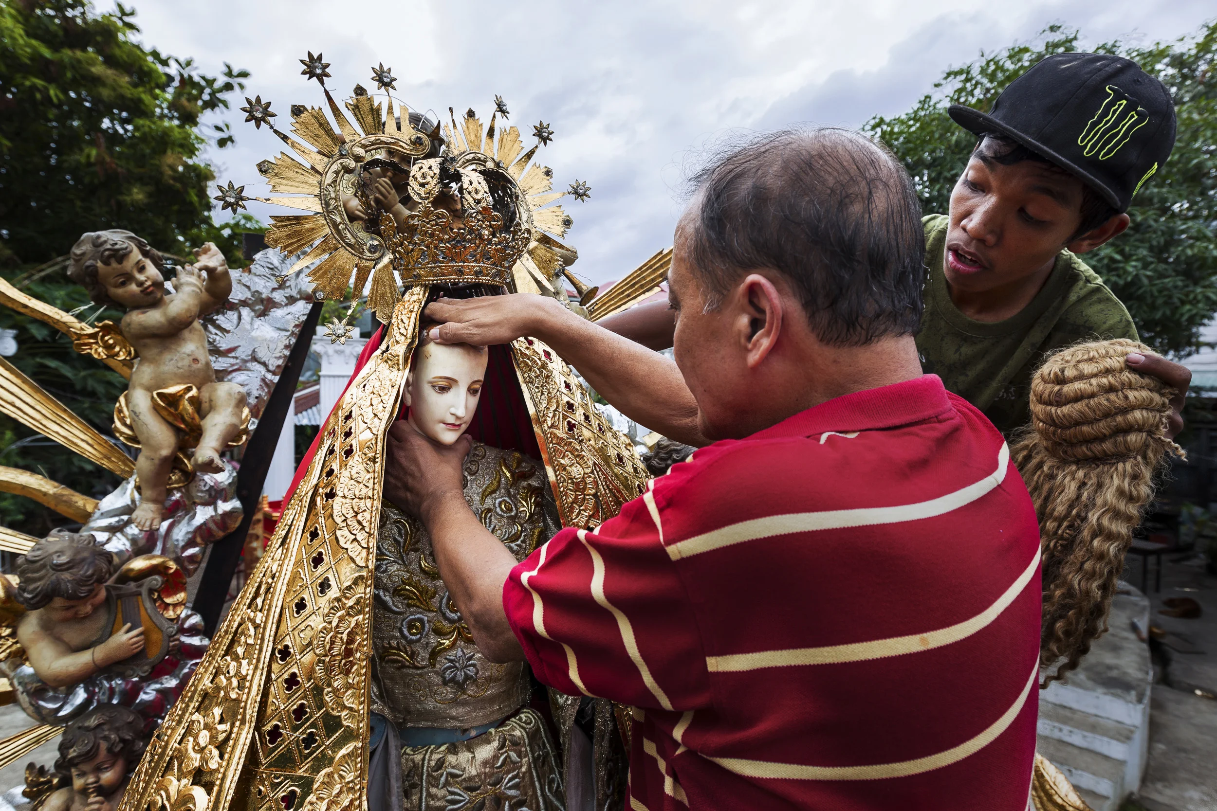 MALOLOS, PHILIPPINES, JANUARY 2012: Dez Battista, an expert on religious icons in the Philippines, prepares his " Nuestra Senora Reina del Ciela," (Our Lady of Heaven," for a religious procession in the streets of Malolos, the birthplace of the Santo Nino phenomenon in the Philippines, January 28 2012. The Icon has head and hands made of solid Ivory, these pieces were comissioned by Mr Battista 15 years ago. This is post Ban Ivory and it is unknown whether this work is made from illegal ivory, of which there is a great deal in the Philippines, mostly used for the carving of religious iconography. The procession will feature 200 similar icons, many of which are made of Ivory. (Photo by Brent Stirton/Reportage by National Geographic.)
