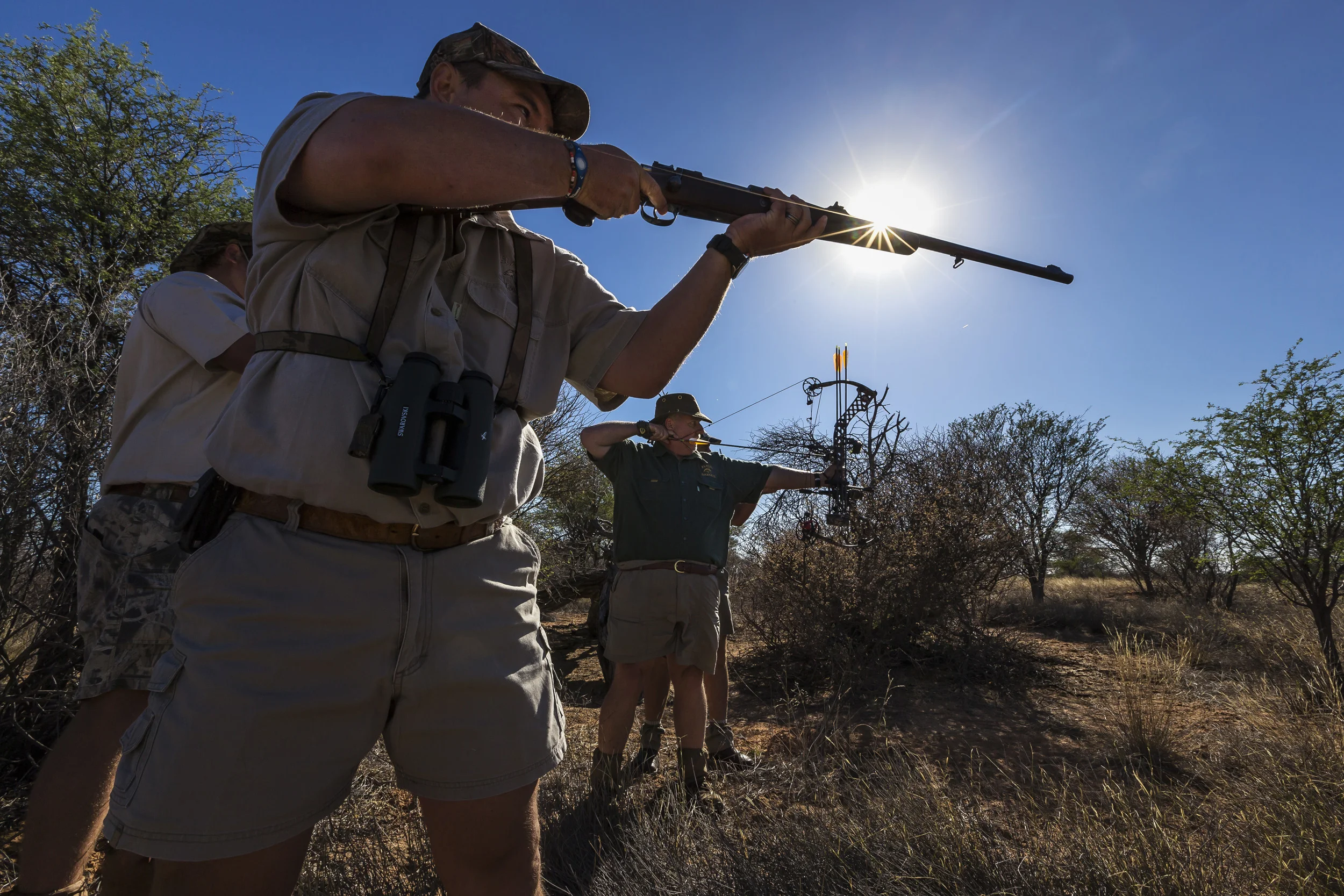 NORTH WEST PROVINCE, SOUTH AFRICA, OCTOBER 2012: American Bow hunter Steve Sibrel hunts a lioness with professional South African hunter guides on a game farm close to the South Africa/Botswana border region, October 19, 2012. Two systems for the hunts exist in two different provinces of South Africa. One practice sees the lion released for a minimal 96 hours into a 3000-hectare area before the hunt can begin. The other practice sees the lion released for 3 months into a minimum 3000-hectare area before it can be hunted. The lioness in these images was released 96 hours ahead of the hunt into the area. Recent global research points to the fact that hunting and breeding programs are necessary components for the survival of lions into the future. These practices go some way towards lessening pressure on wild lion populations as well as preserving a strong lion DNA base and a future repository for lions for areas where they have been decimated. The hunting industry is also a strong employer in Africa, with over 1.4 million square kilometers given over to hunting concessions. This is a landmass more than 20% higher than that given over to Wildlife Conservation areas. More than 18000 hunters come to Africa every year and the money high-end dangerous game hunting brings to the continent goes some way to preserving the land mass set aside for hunting. The South Africa Predators Breeders association is making strides towards a more regulated industry, with a charter and code of conduct in the works, which is expected to bring a stronger emphasis on ethical practice into play. (Photo by Brent Stirton/Reportage for National Geographic Magazine.)