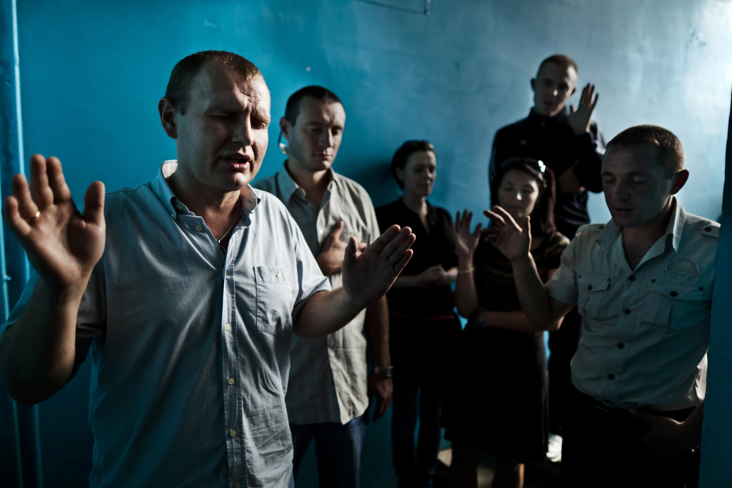 KIEV, UKRAINE, AUGUST 2011: A Christian Ukrainian counselling group made up of ex addicts prays in a stairwell at their office in Kiev, Ukraine, 24 August 2011. (Photo by Brent Stirton/Reportage by Getty Images.)