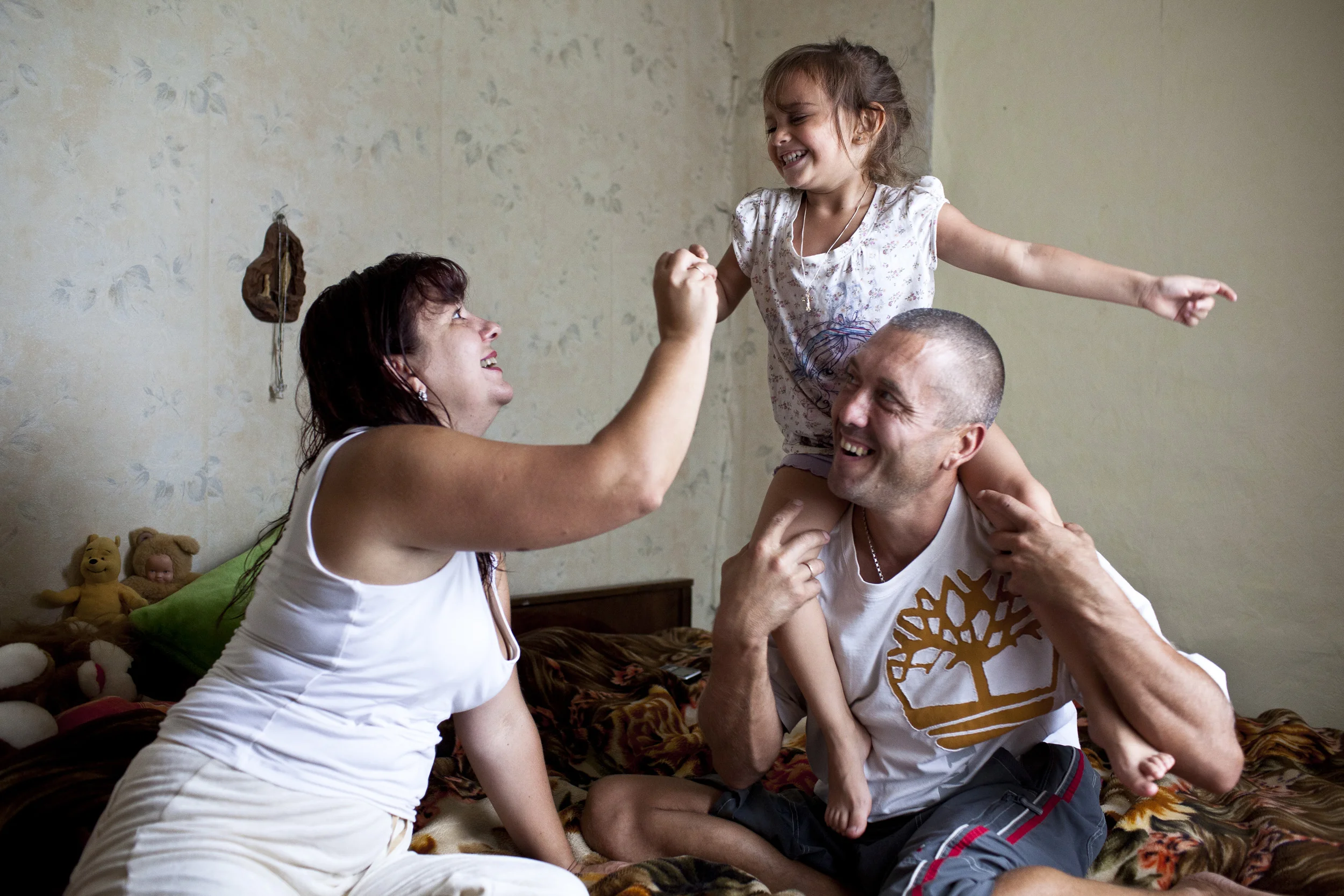 DONETSK, UKRAINE, SEPTEMBER 2011: A HIV+ man and his HIV negative wife and her adopted daughter in their home in Donetsk, Ukraine, 1 September 2011. He met her when he came for treatment for his Tuberculosis at a clinic where she worked as a doctor and they have been together ever since. (Photo by Brent Stirton/Reportage by Getty Images.)